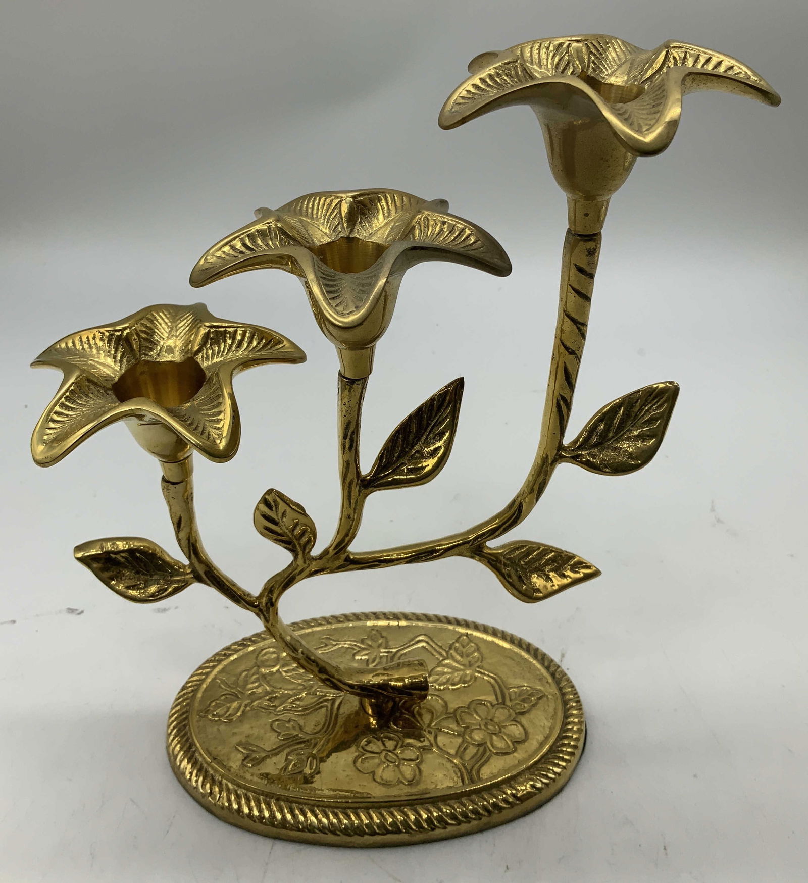 Vntg 3 Branch Floral Gilt Metal Candelabra INDIA: Candelabra is gilt metal & features three branches formed in the shape of flowers. Piece is textured. Holds 3 candles. Signed & marked on underside. Reads, MADE IN INDIA. Surface wear consistent to ag