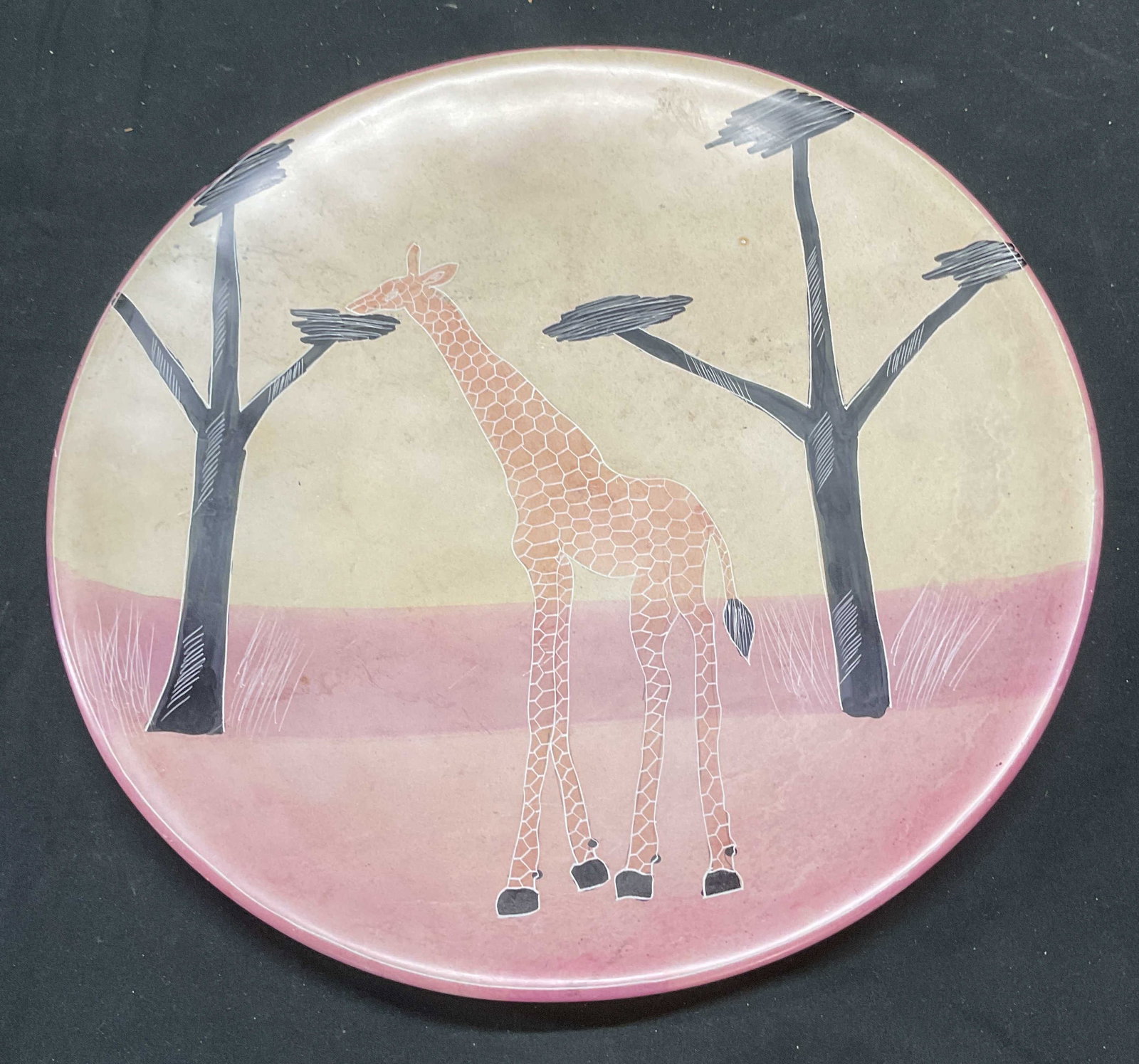 Besmo Hand Carved Stone Giraffe Plate, Kenya: Besmo hand carved stone plate with giraffe and tree motif. Hand painted decoration. Signed on label. Label reads Genuine Besmo Product Hand Carved in Kenya. Measures approx 12 inches wide. Piece has w