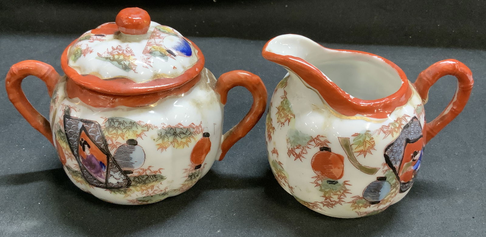 Set2Vntg Japanese Geisha Porc Creamer & Sugar Bowl: Pieces are porcelain material & depict hand-painted geisha figurines. Comes with lidded sugar bowl & creamer. Red accents on trims. Surface wear consistent to age, use & exposure. Measurements: length