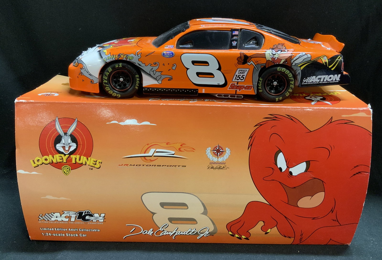 NASCAR Earnhardt #8 Looney Tunes 1:24 Die-Cast: Lot includes, Dale Earnhardt Jr. #8 Looney Tunes Rematch. 2002 MONTE CARLO 1:24 die-cast model. Car features images of Looney Tunes characters. Orange & white tones. Comes with original box. Surface w