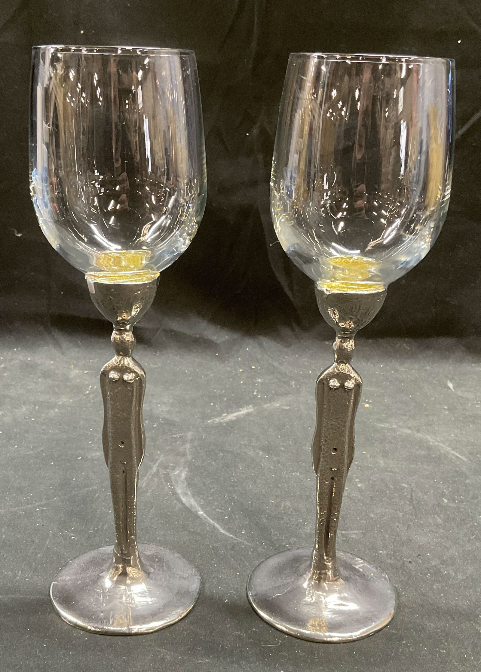 Pair Pewter Figural Stem Wine Glasses: Pair of vintage brutalist style pewter stem wine glasses. Style of Patrick Meyer, no visible signature. Female figure stems. Measures approx 2.75 x 10 inches. Some wear consistent with exposure. Wine 