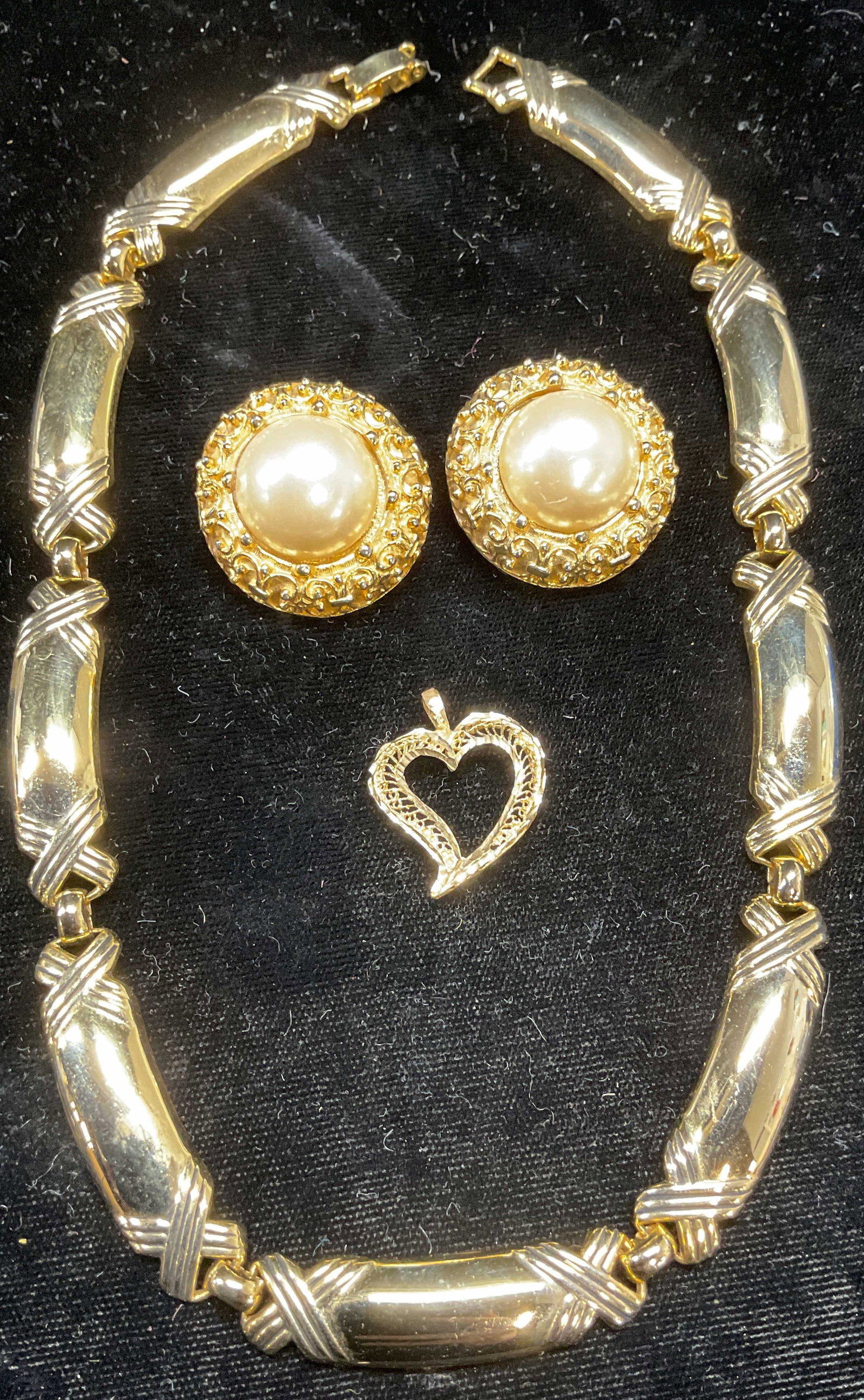Lot 3 Gold Tone Necklace, Earrings, Pendant: Lot of 3 jewelry pieces. Gold tone x panel choker necklace. Gold tone faux pearl earrings. Gold tone open heart pendant. Necklace drop length approx 6.75 inches. Earrings approx 1 inches wide. Pendant