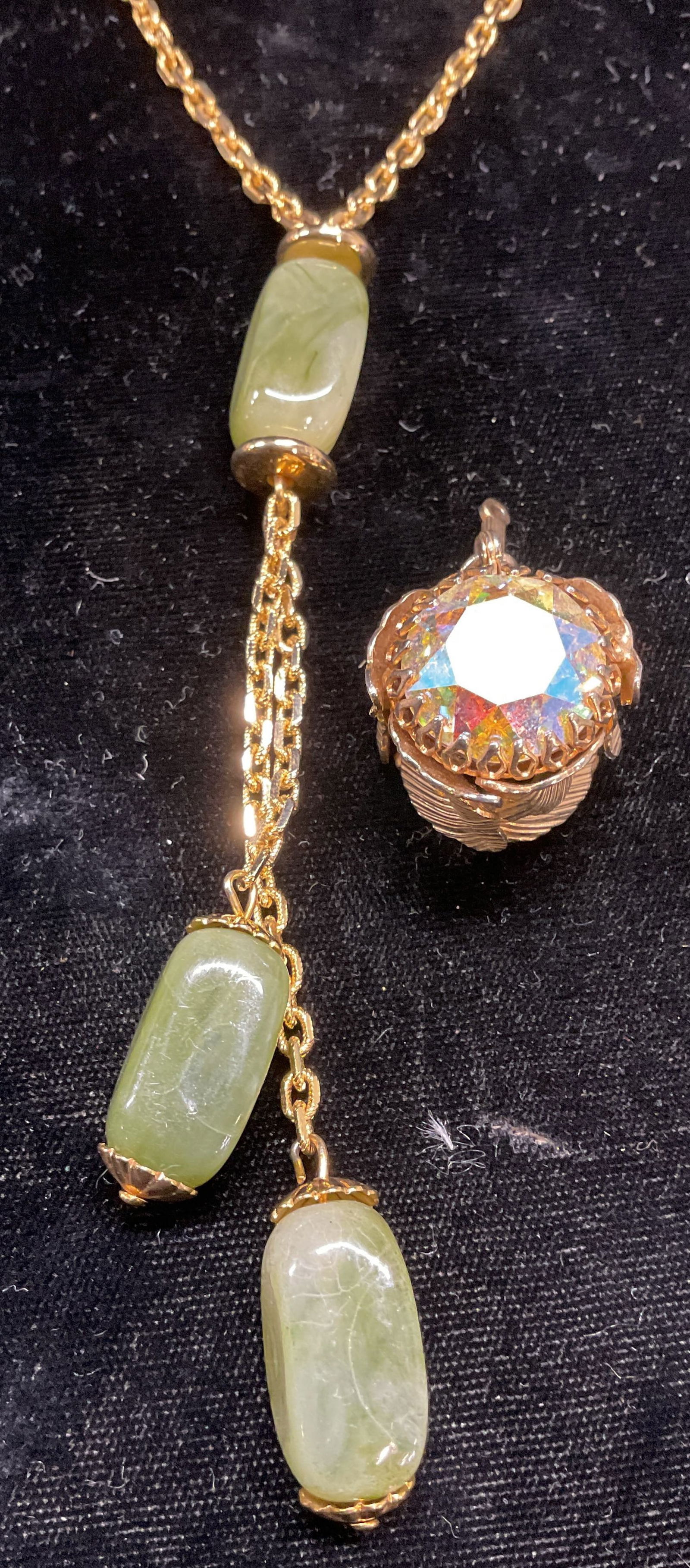 Lot 2 Faux Jade Necklace & Crystal Pendant: Lot of 2 jewelry pieces. Gold tone faux jade lucite pendant necklace and gold tone crystal pendant. Necklace drop length approx 12.25 inches. Pendant approx 1 inch long. Necklace clasp needs repair. S