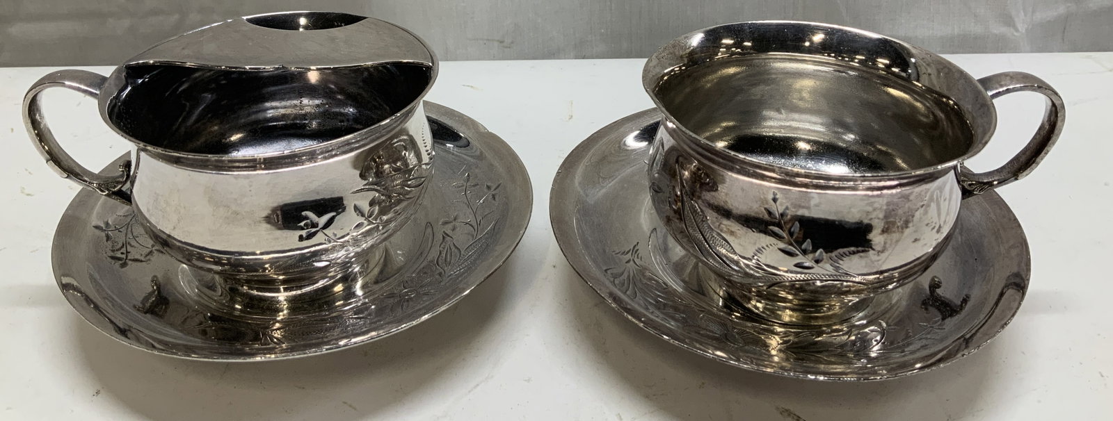 Vntg Barbour Silver Co. Floral Cups W Saucers: Lot includes, 2 saucer, 1 mustache cup & 1 teacup. Pieces feature an engraved floral & scrollwork pattern along the sides & rims. Signed & marked on underside. Reads, BARBOUR SILVER CO. QUADRUPLE. SIL