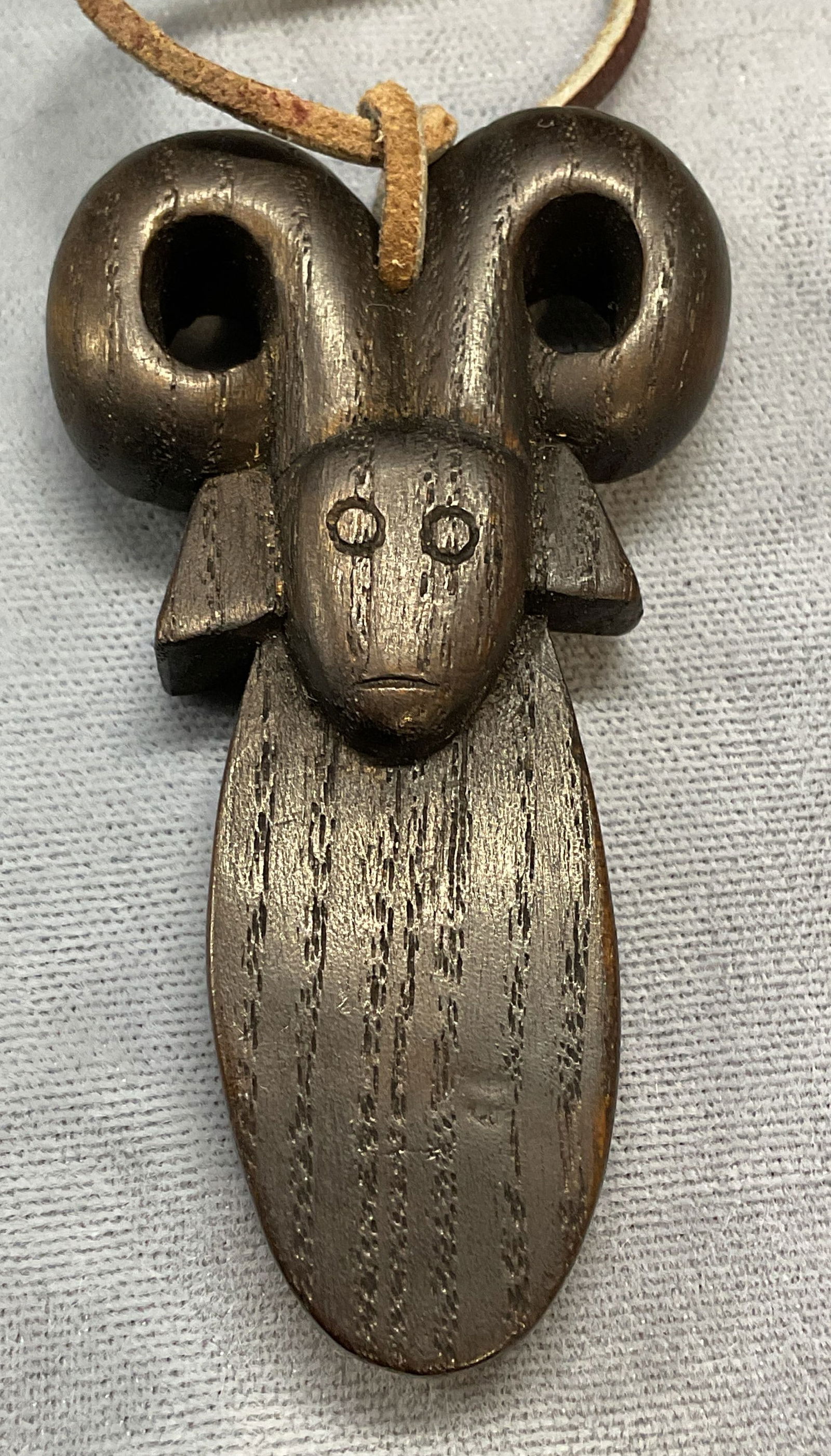 Hand Carved Wood Ram Pendant Necklace: Hand carved wood ram motif pendant on leather cord. Dependent measures approx 2.5 x 1.5 inches. Some scratching. Jewelry, estate jewelry, costume jewelry, cocktail jewelry, fashion jewelry, accessors,