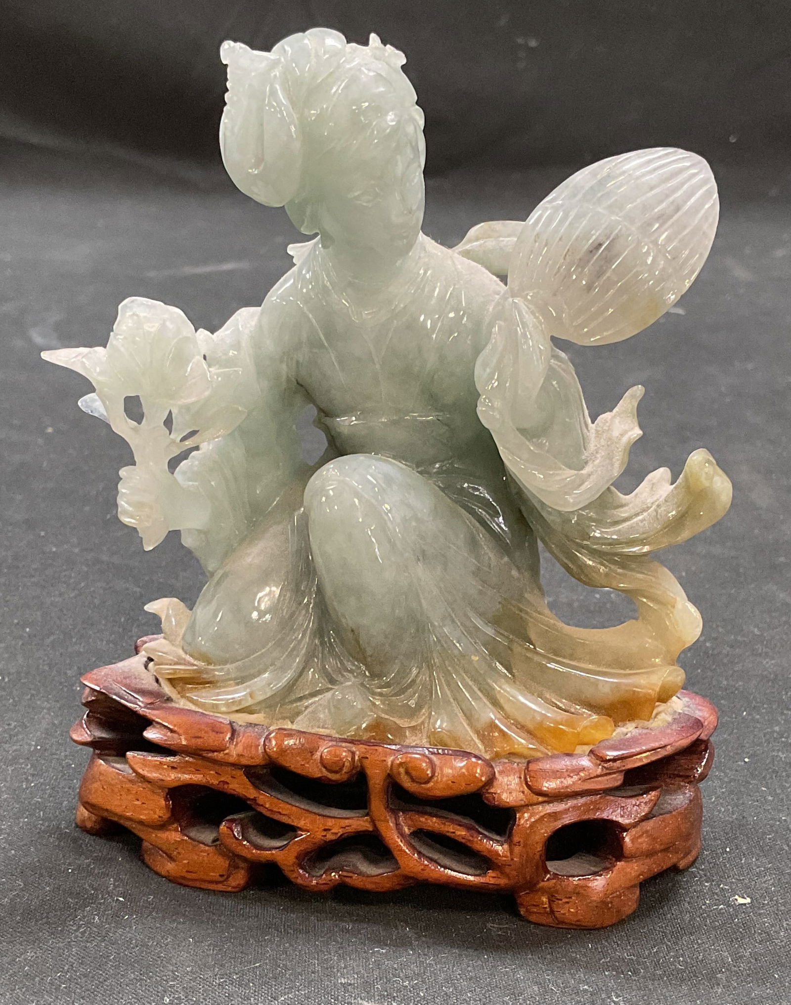 Asian Carved Jade Woman & Fan Figurine & Base: Asian carved jade figurine depicting a woman holding a fan on wood stand. Measures approx 3.5 x 2 x 4.25 inches. Some wear consistent with exposure. Jade figurine, woman figurine, Asian figurine, coll