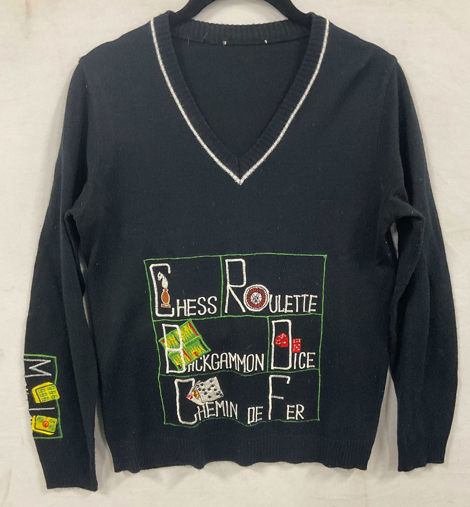 Vintage Embroidered Black Casino Game Sweater: Vintage black knit v neck sweater with embroidered casino card gambling game design. Feels like wool, possibly synthetic. Measures approx 16 inches across. Some wear including pilling. Embroidered swe