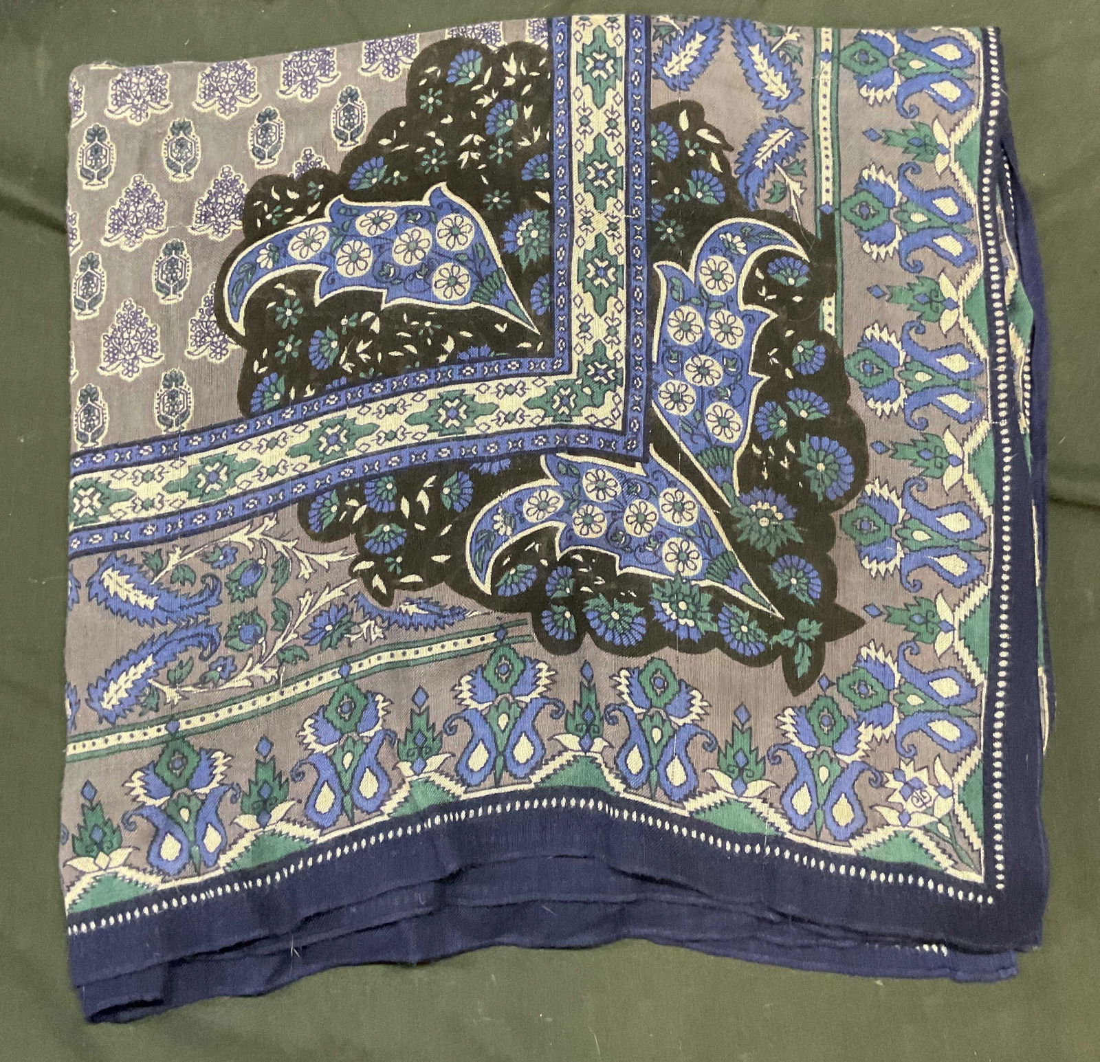 Blue & Grey Floral Print Knit Scarf: Blue and grey knit scarf with floral print. Feels like wool, possibly synthetic. Measures approx 74 inches long. Some wear including small holes and pulls. Scarf, blue scarf, grey scarf, floral scarf,