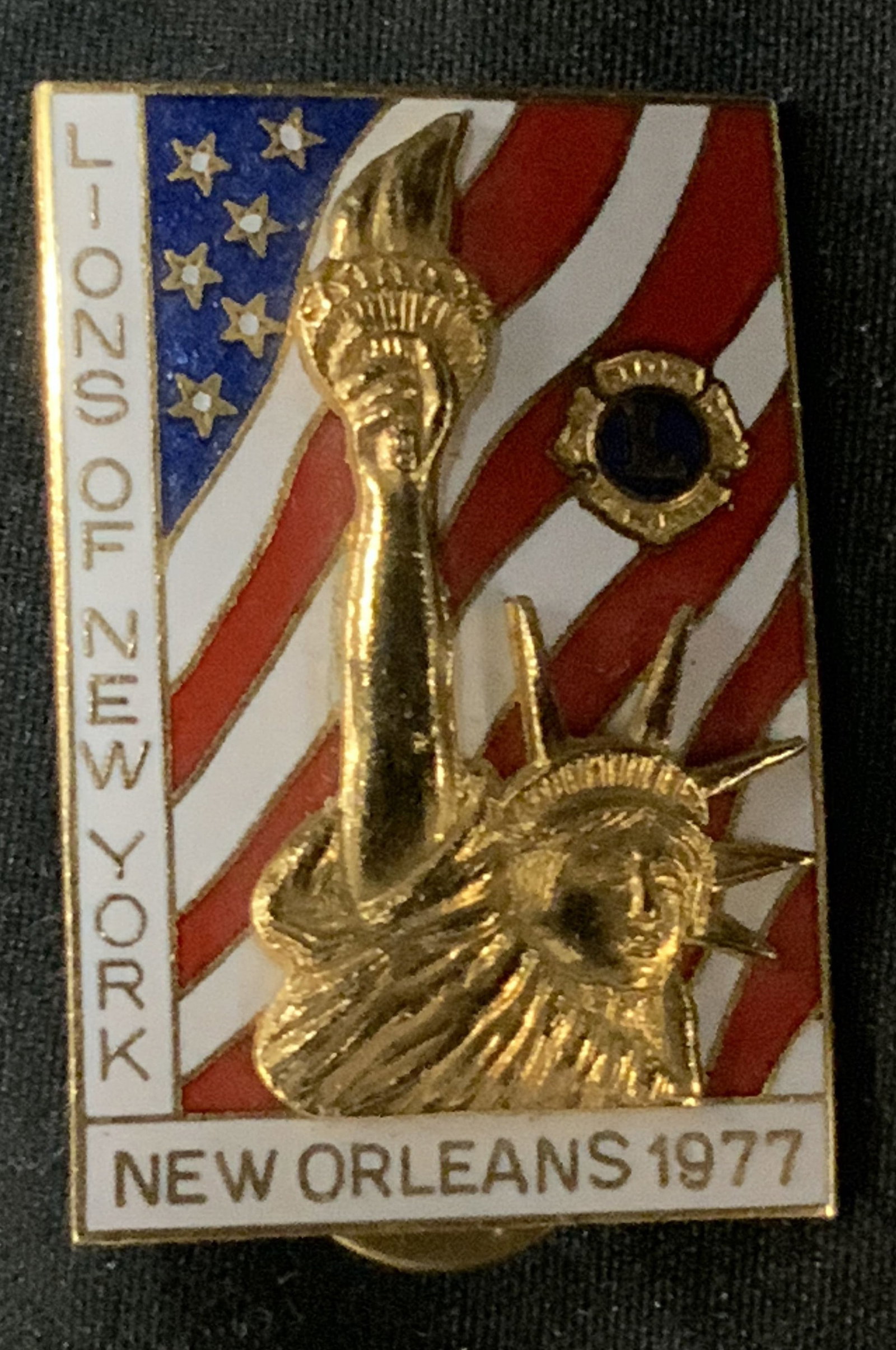 Vntg Lions Club 1977 NY Gold-Toned Lapel Pin: Vntg Lions Club 1977 NY Gold-Toned Lapel Pin Lapel pin features the Statue of Liberty & wording that reads LIONS NEW YORK, NEW ORLEANS 1977. Signed & marked. Surface wear consistent to age, use & expo