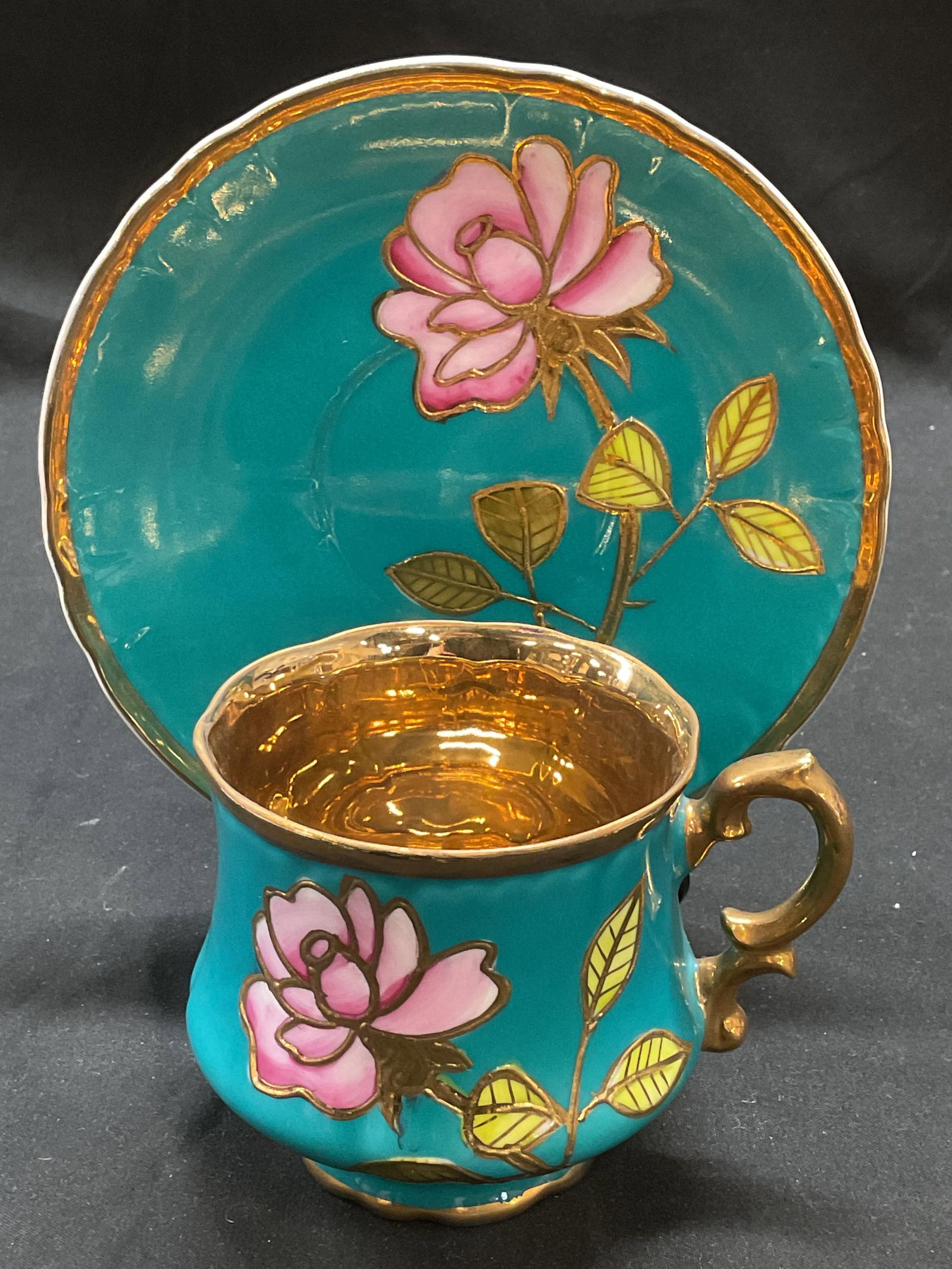 Vtg Arnart Gilt Blue Porcelain Teacup & Saucer: Vintage Arnart porcelain teacup and saucer in blue with gilt decoration and floral pattern. Signed. Saucer approx 5.75 inches, teacup approx 3.25 x 3 inches. Some wear including scratching observed. A