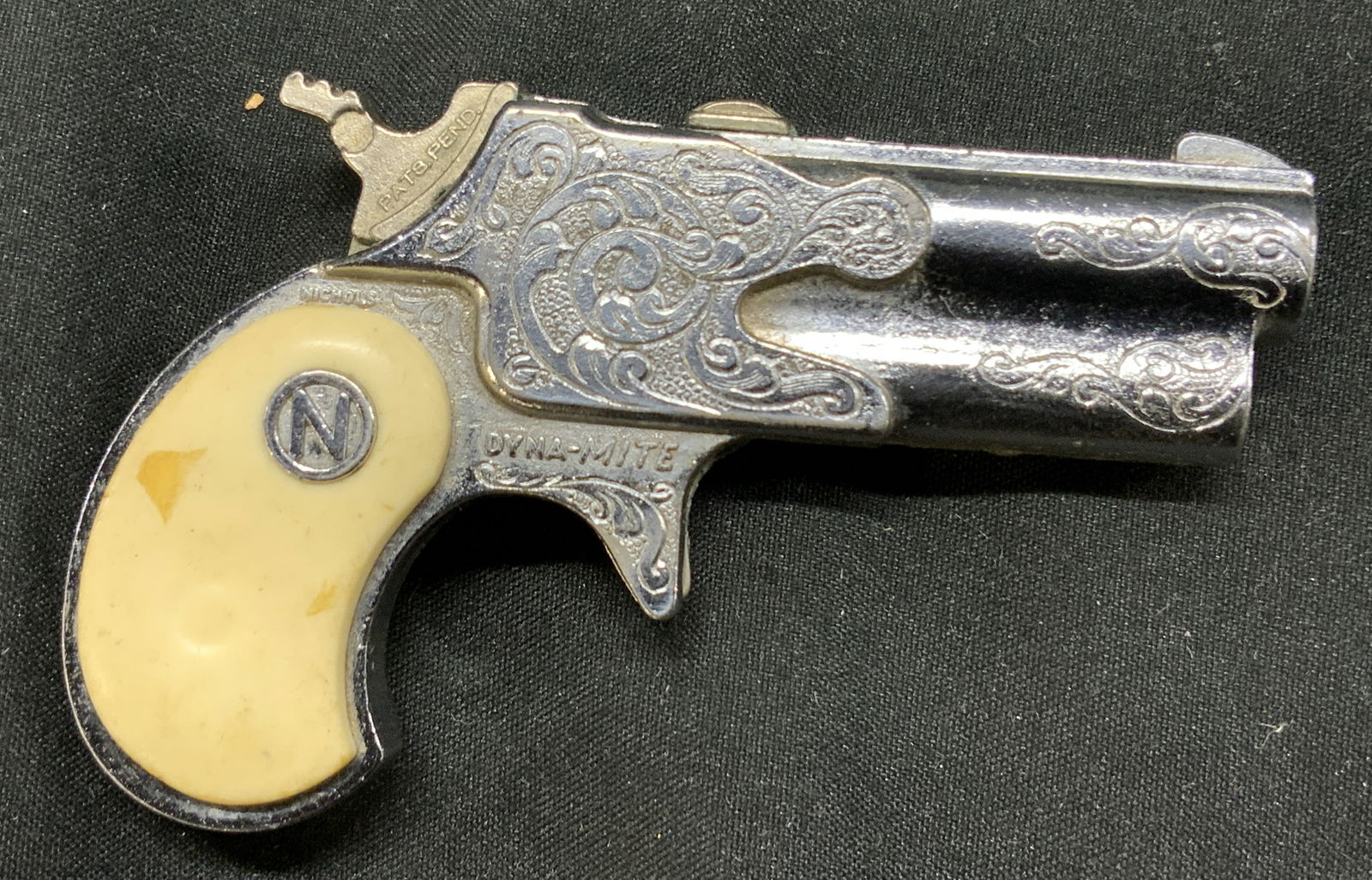 Vintage Nichols Dyna-Mite Derringer Cap Gun: Vintage Nichols Dyna-Mite Derringer Cap Gun Collectible cap gun made by Nichols in Jacksonville TEXAS. Signed & marked. Surface wear consistent to age, use & exposure. Measurements: length 3.3in x wid