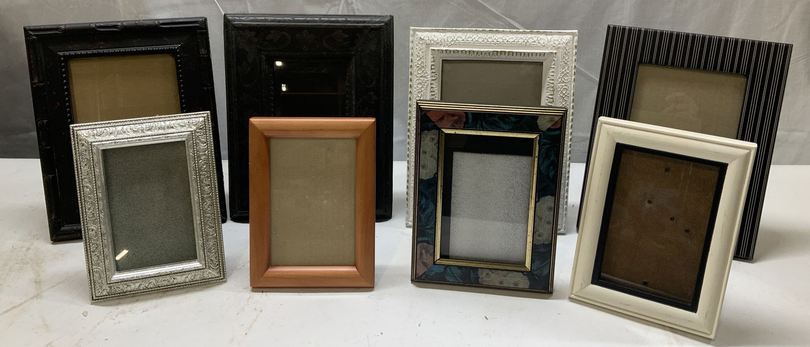 Lot 8 Assorted Wooden Picture Frames MELANNCO+: Lot includes, 8 assorted picture frames. Picture frames appear to be wooden or possible resin material. Features floral, ornate, striped & plain patterns. Picture frames vary in size & color. Signed &