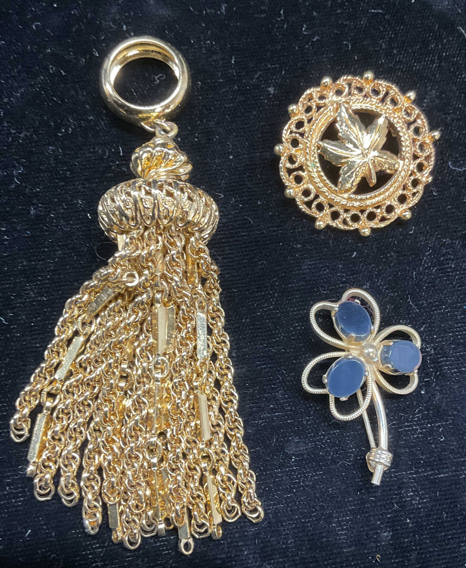 3 Burt Cassell Gold Filled Semiprecious Brooch+: Lot of 3 jewelry pieces. Vintage Burt Cassell 12k gold filled clover leaf brooch with blue semiprecious stones. Signed. Measures approx 1.25 x 1 inches. Gold tone filigree leaf motif brooch. Measures 