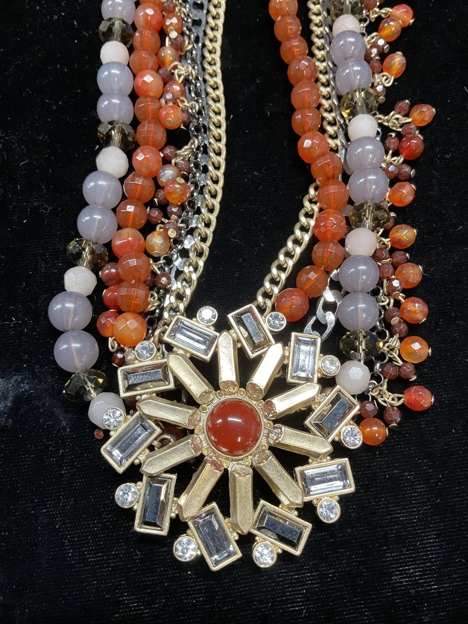 Gold Tone Semiprecious Crystal Necklace: Gold tone pendant necklace with orange semiprecious beads and grey lucite and crystal accents. Drop length approx 7.5 inches. Some scratching. Jewelry, estate jewelry, costume jewelry, fashion jewelry