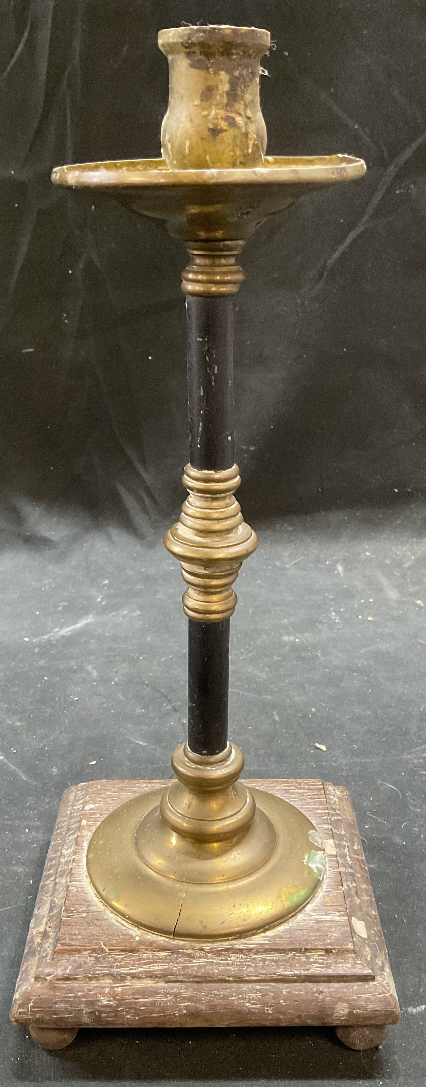 Vintage Brass & Wood Candle Holder: Vintage candle holder. Brass with black enamel and wood plinth base. Measures approx 4.5 x 4.5 x 11.5 inches. Wear including patina, warping, splitting, and residue. One foot needs replacement. Candle
