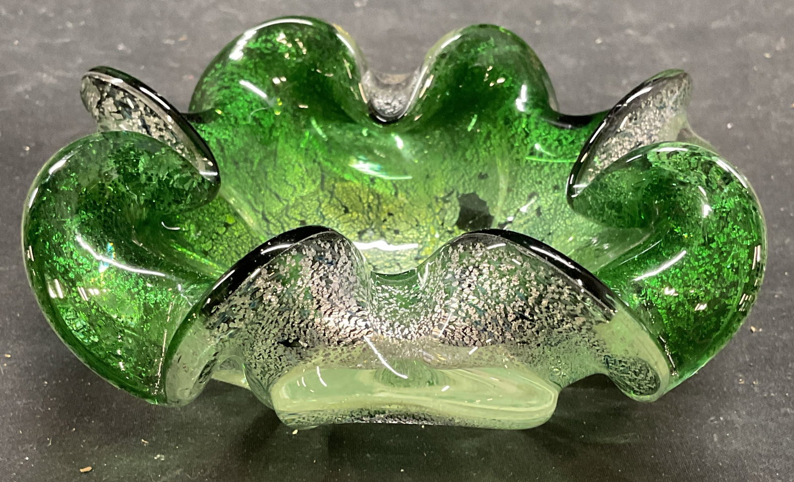 MURANO Green Silver Art Glass Trinket Dish: Vintage Murano Art glass hand blown trinket dish or bowl with curved rim. Cased clear and green with silver leaf. No signature. Measures approx 5 x 5 x 2.25 inches. Some scratching. MURANO bowl, MURAN