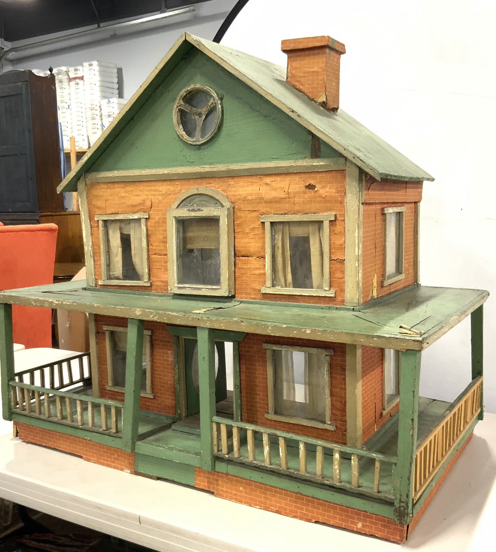 Vintage XL Wooden Dollhouse W Porch 33in: Dollhouse is vintage. Piece is wooden and plastic. Dollhouse has orange and green tones. Piece has wrap around porch. Backside is open. Piece measures approximately 33 inches wide 31 inches tall 20 in