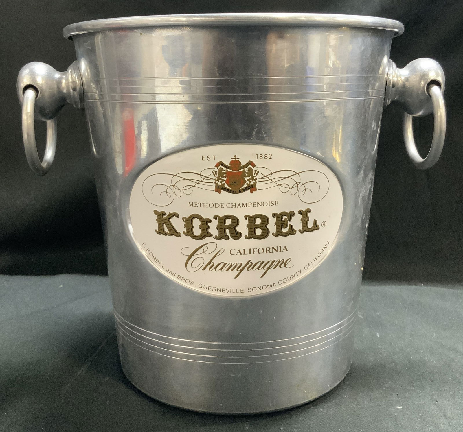 Vntg KORBEL Advert. Metal Champagne Bucket FRANCE: Vintage advertising metal champagne bucket. Bucket reads, METHODE CHAMPENOISE. KORBEL. CALIFORNIA. CHAMPAGNE. F. KORBEL & BROS. GUERNEVILLE, SONOMA COUNTY, CALIFORNIA. MADE IN FRANCE. Bucket features