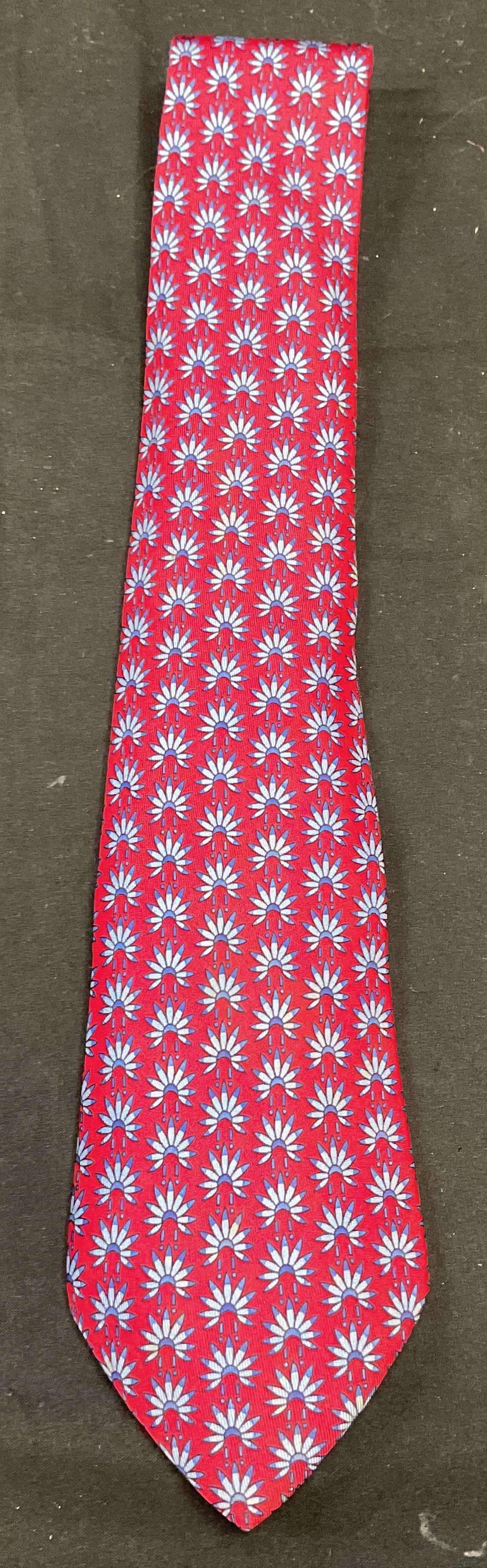 Hermes Red Blue Graphic Print Silk Tie France: Hermes Graphic print silk tie in red and blue. Native American headdress motif. Signed. Made in France. Measures approx 57 inches long. Some blemishes. Hermes, Hermes tie, luxury tie, luxury accessori