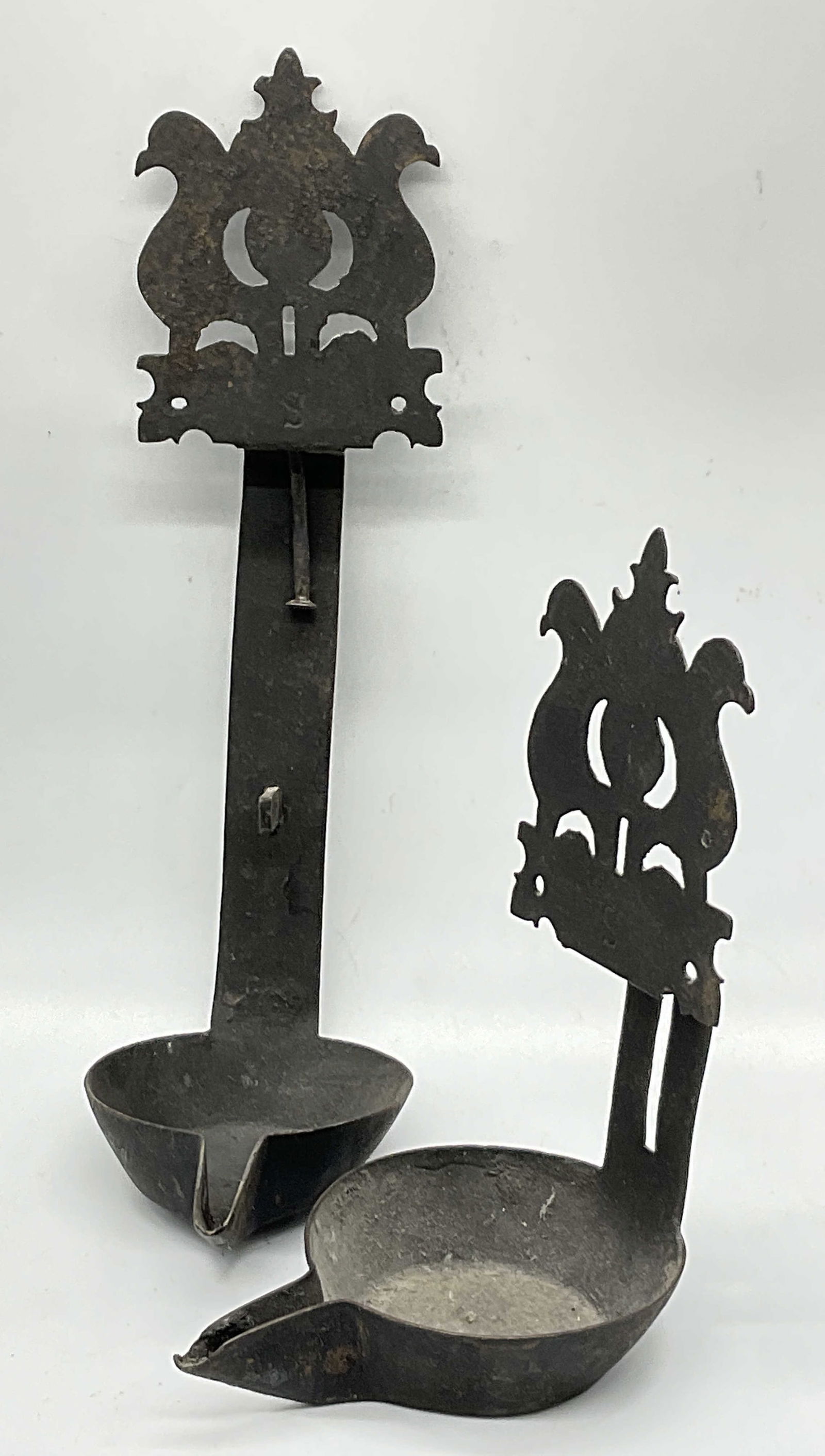 Antique Cast Iron Betty Lamp / Cruise Lamp: Antique Cast Iron Betty Lamp / Cruise Lamp. Black hued. Open metalwork designs to the piece. Both are marked with the letter S. Betty lamps were oil burning lamps commonly used in the 18th and 19th ce