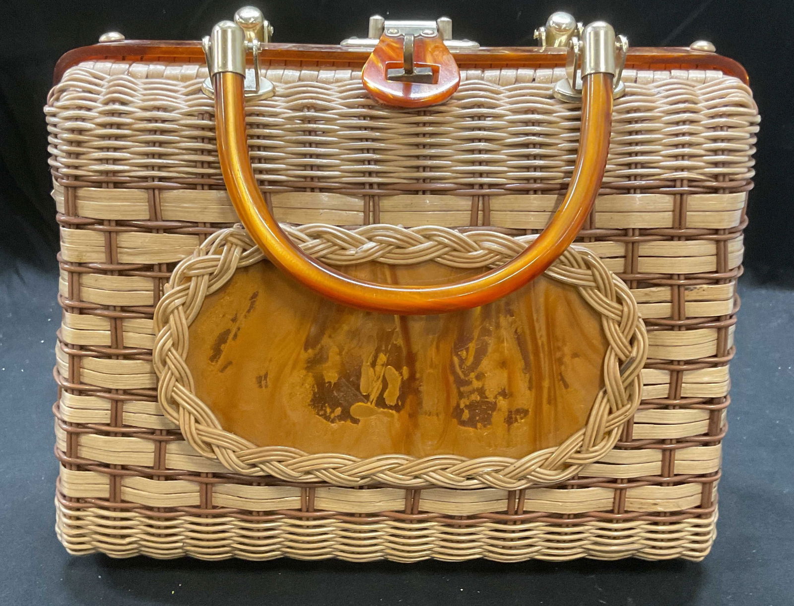 Vtg Princess Charming Atlas Lucite Wicker Handbag: Vintage Princess Charming by Atlas woven wicker handbag with faux wood lucite accents. Faux leather lining. Interior tag reads Atlas, Hollywood Florida, made in Hong Kong. Measures approx 10.5 x 4.5 x