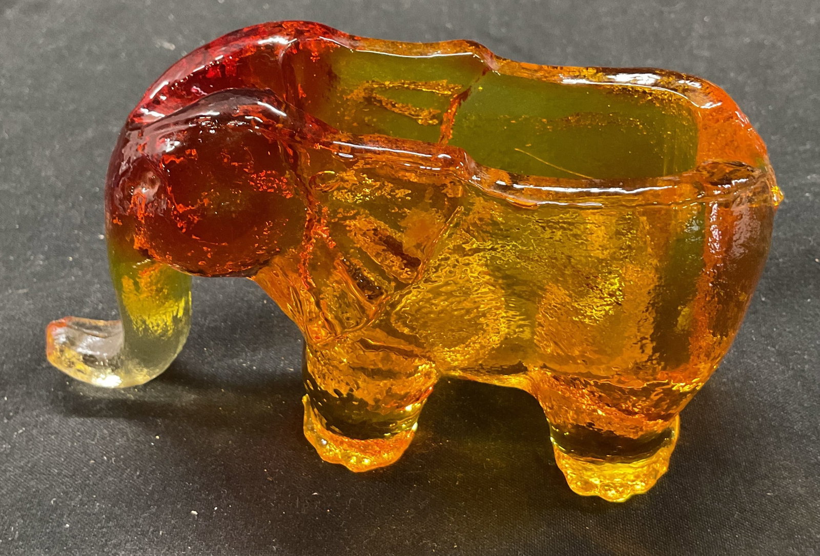 Vtg Kanawha Amberina Glass Elephant Ashtray: Vintage Kanawha amberina glass elephant ashtray. Orange, amber, clear glass elephant figurine. 5 x 1.5 x 2.5 inches. Some surface wear consistent with exposure. Kanawha, amberina glass, glass art, ash