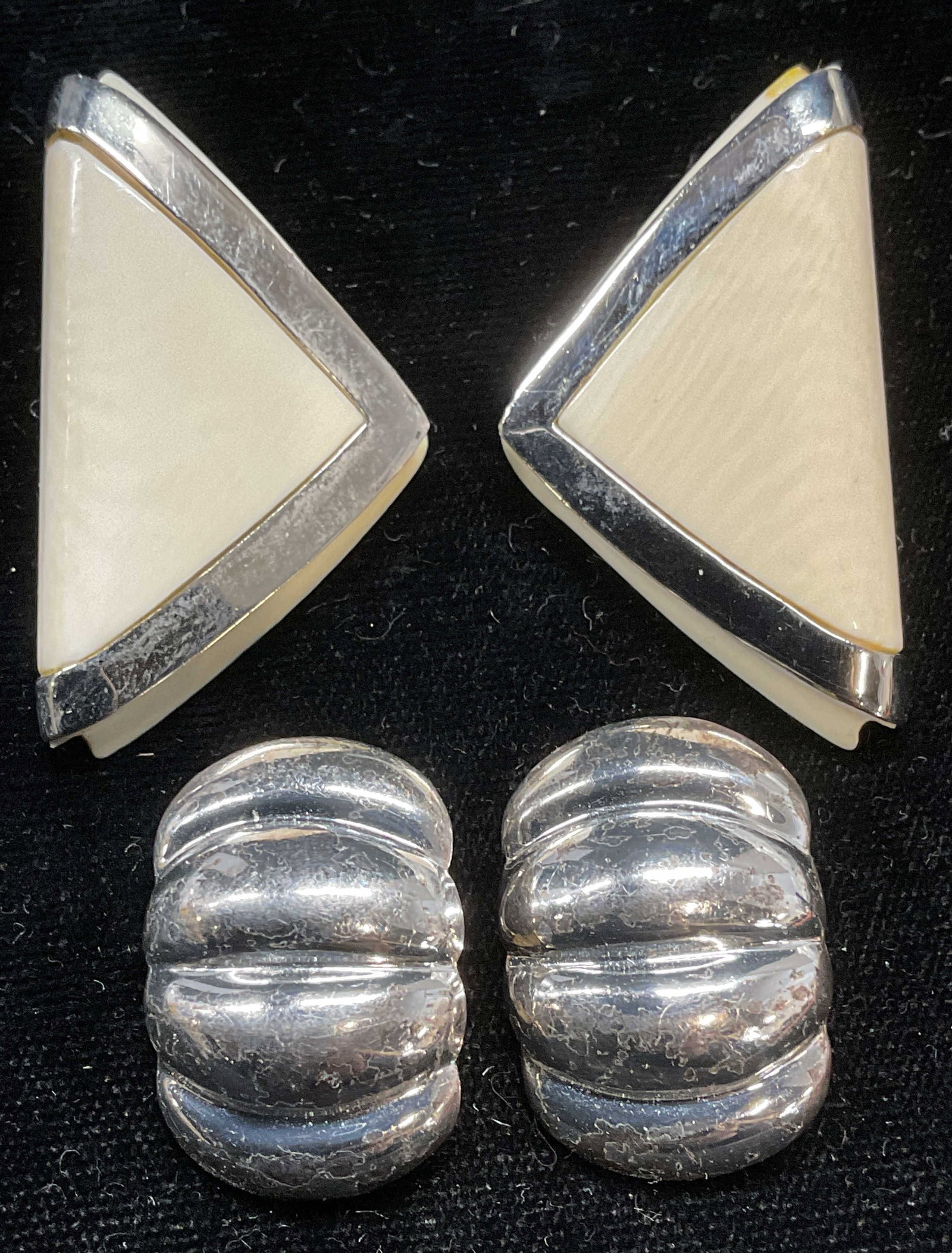 Lot 2 Sterling Silver & Bone Earrings: Lot of 2 jewelry pieces. Sterling silver raised band earrings. Marked sterling. Measure approx 1 x .75 inches. Total weight 8.5 grams. Carved bone earrings with sterling silver accent. Marked sterling