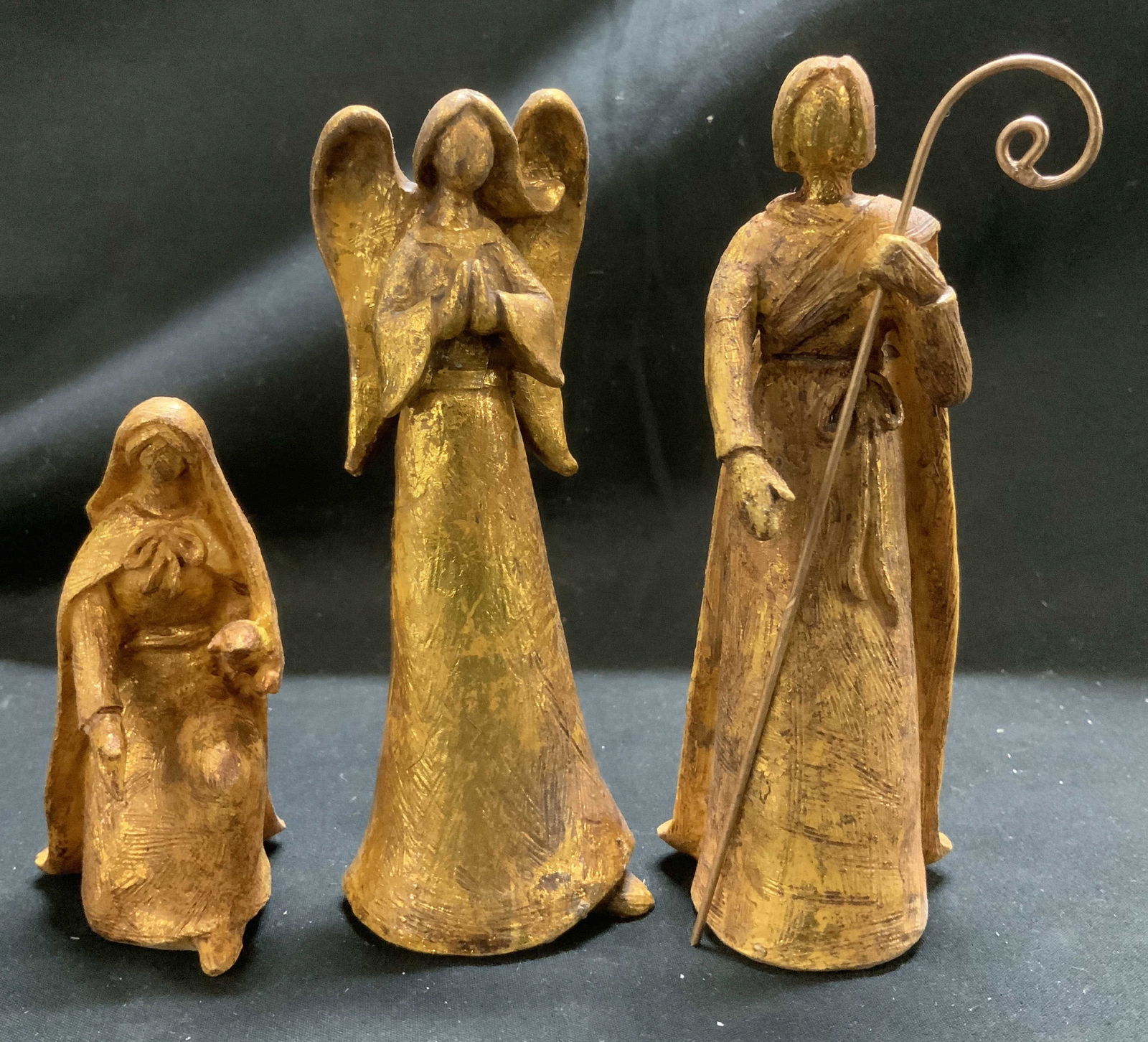 Lot 3 Nativity Gold Toned Resin Figurines: Figurines are resin material & have a gold toned finish. Features a praying angel, kneeling Mary & Shepard. No visible signature or markings. Surface wear consistent to age, use & exposure. Measuremen