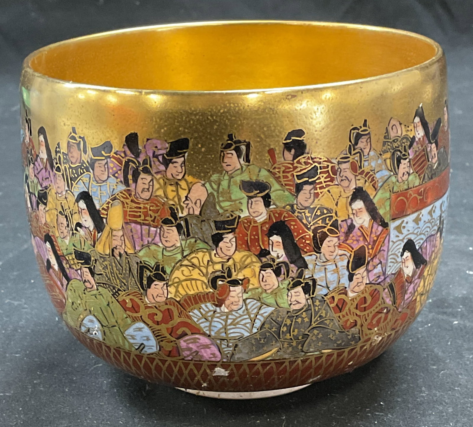 Signed Japanese Kutani Ware Porcelain Bowl: Signed Japanese Kutani ware porcelain bowl. Hand painted. Gilt interior and exterior. Traditional figural motifs. Signed on underside. Measures approx 4.5 x 3.75 inches. Some scratching and loss to pa