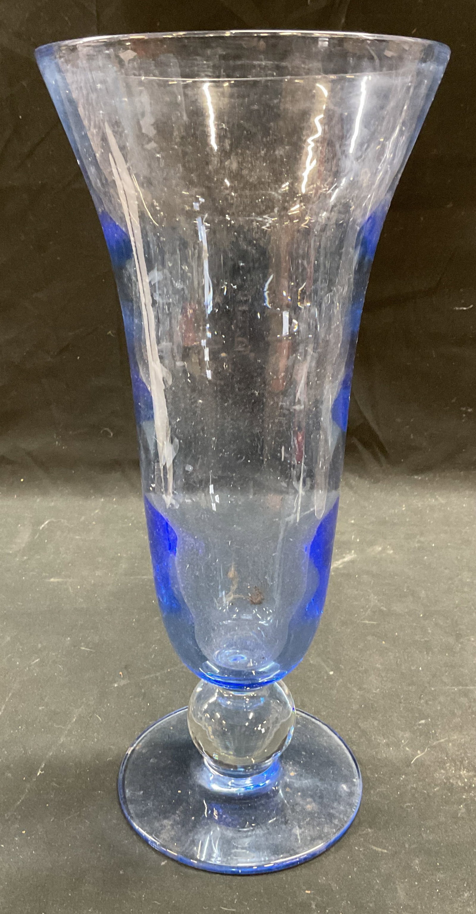 Blue Art Glass Footed Vase: Blue blown art glass vase with clear ball footed base with fluted rim. Measures approx 6 x 12.75 inches. Some scratching. Art glass vase, blue vase, footed vase, home decor, home accessories, table de