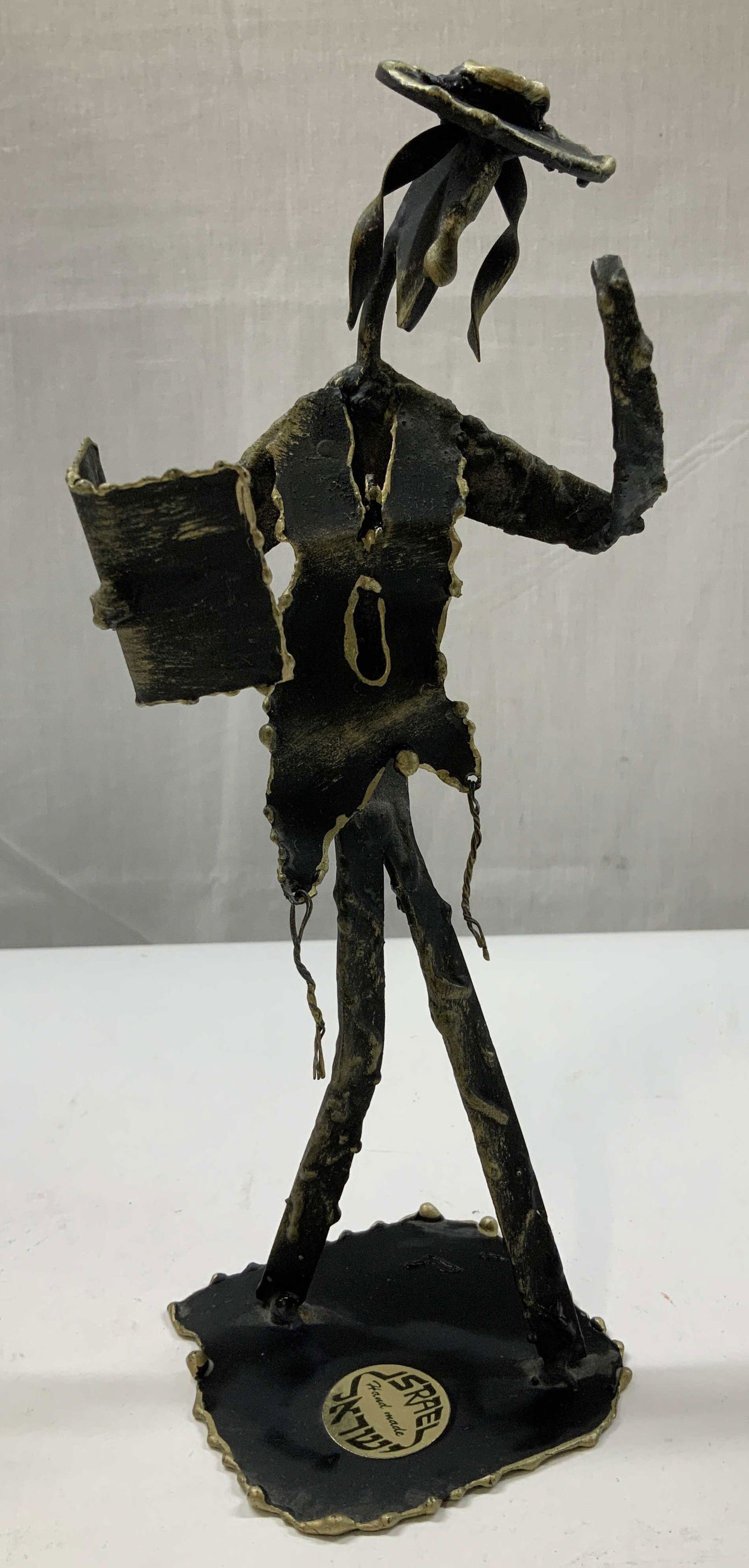 Vntg Judaica Hassidic Man Metal Figurine ISRAEL: Figurine appears to be made of material(magnetic) finished in black and gold patina. Depicts a hand-made Hassidic man wearing a hat and holding what appears to be a book. Figure is standing on a squar