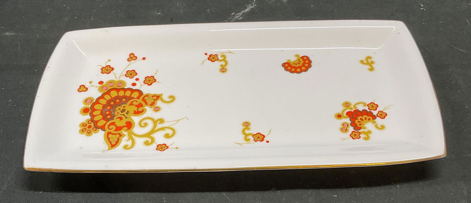 Minton Oberon Fine China Tray, England: Minton fine bone china rectangular tray. Oberon platter. Decorative floral trim in orange and gold. Signed. Made in England. Measures approx 11.5 x 5.75 inches. Some scratching. Minton tray, Minton pl