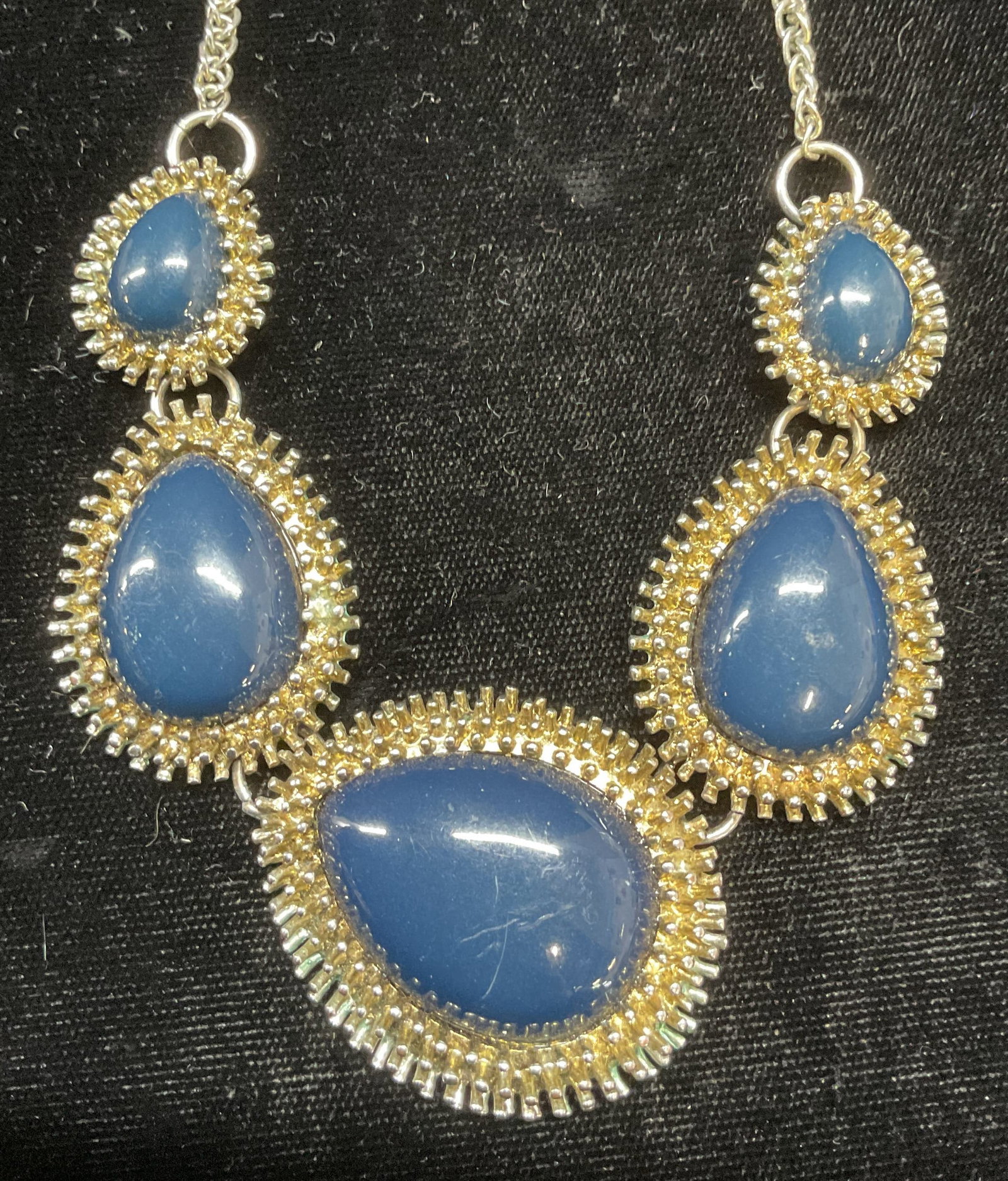 Vintage Silver Tone Blue Teardrop Necklace: Vintage silver tone necklace with blue faux cabochon teardrop pendants. Drop length approx 10 inches. Some wear including scratching observed. Jewelry, estate jewelry, costume jewelry, cocktail jewelr