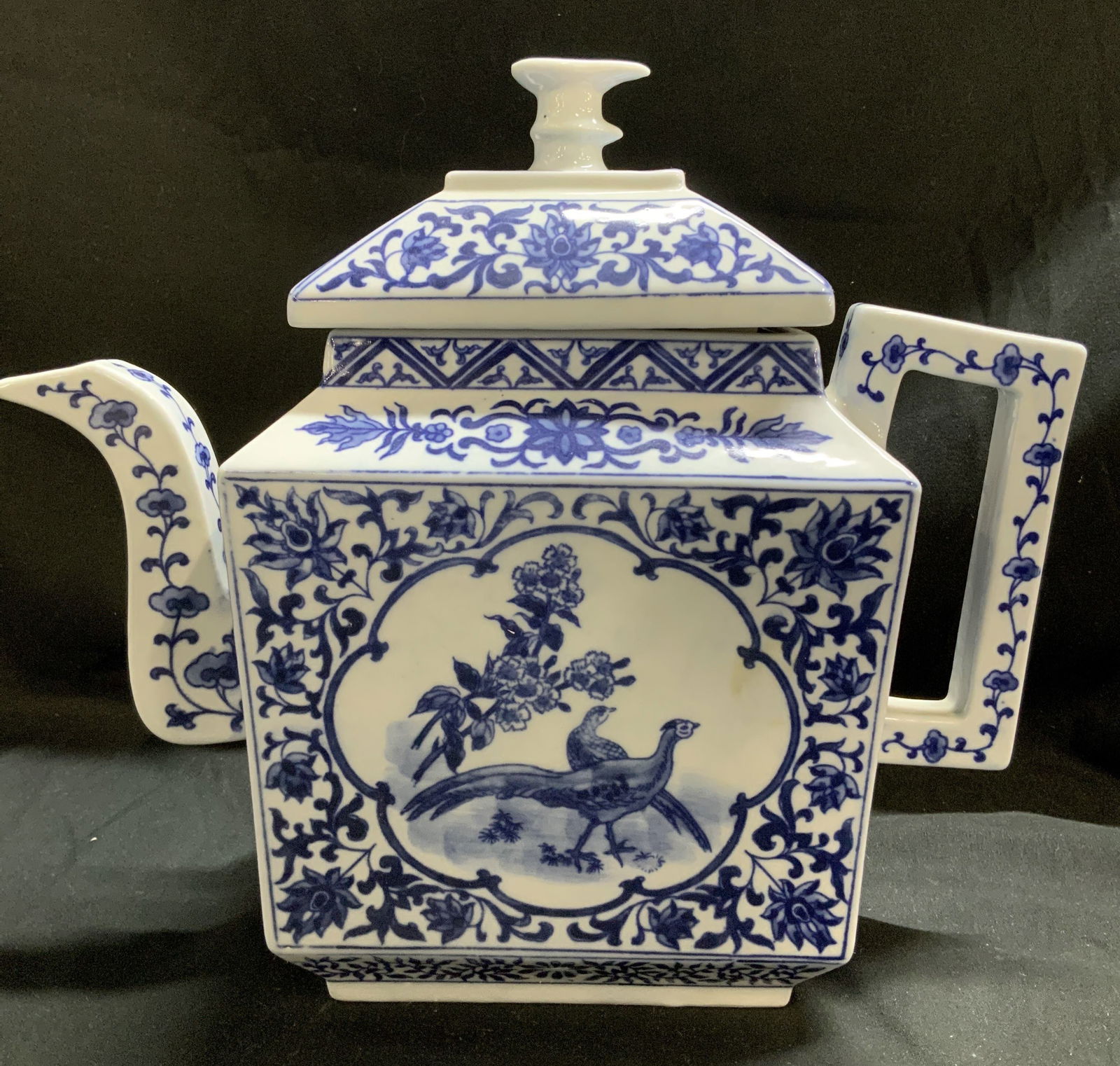 Vntg Chinese Blue & White Floral Porc Teapot: Marked with Asian characters on underside. Teapot is porcelain & features floral & pheasant motifs. Teapot is blue & white toned. Glossy finish. Surface wear consistent to age, use & exposure. Measure