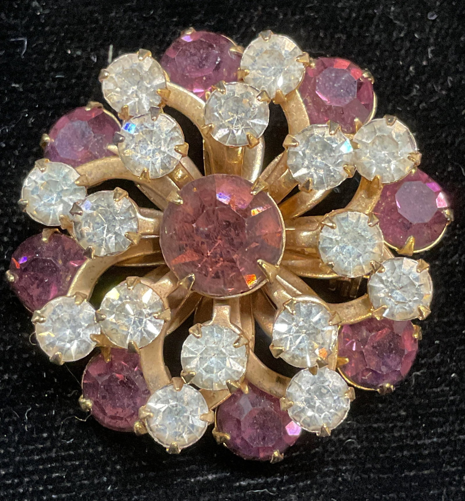 Vintage Gold Tone Crystal Flower Brooch: Vintage gold tone flower brooch with colorless and purple crystals. Measures approx 1.25 inches wide. Some scratching. Jewelry, estate jewelry, costume jewelry, cocktail jewelry, fashion jewelry, acce