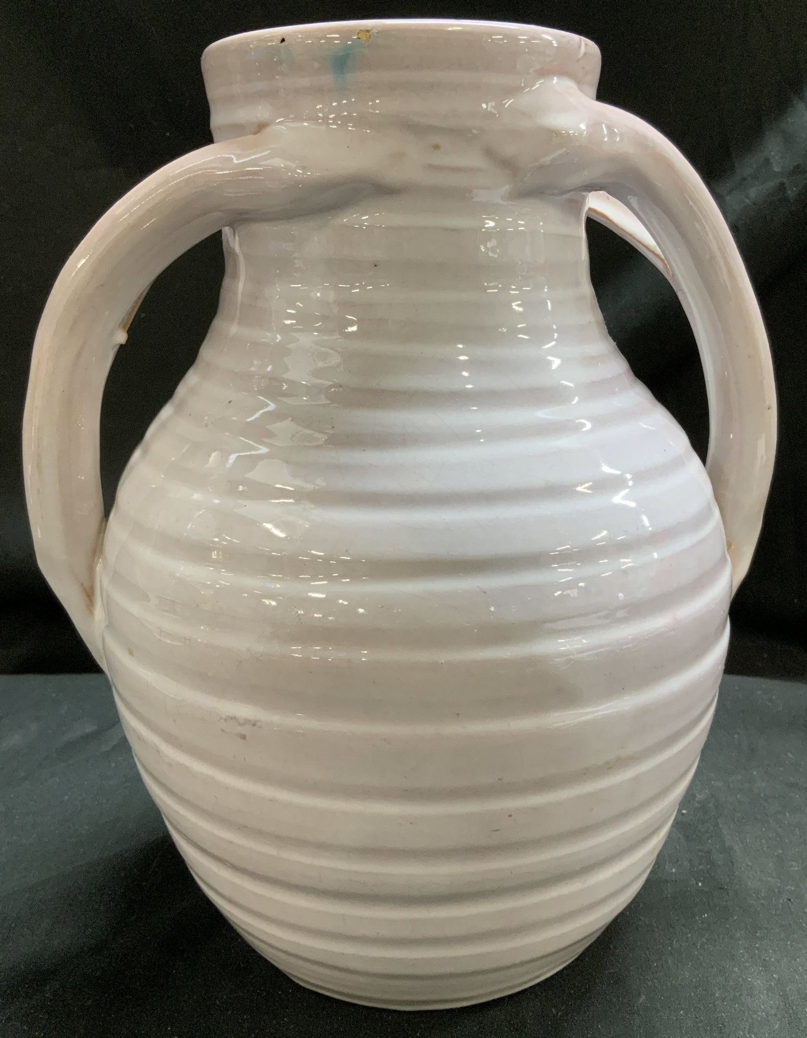 Vntg Two Handled Ribbed Ceramic Vessel: Ceramic vessel featuring a round body w horizontal ribbing. Feature arched loop handles. Glossy finish. No visible signature or markings. Surface wear consistent to age, use & exposure. Measurements: 