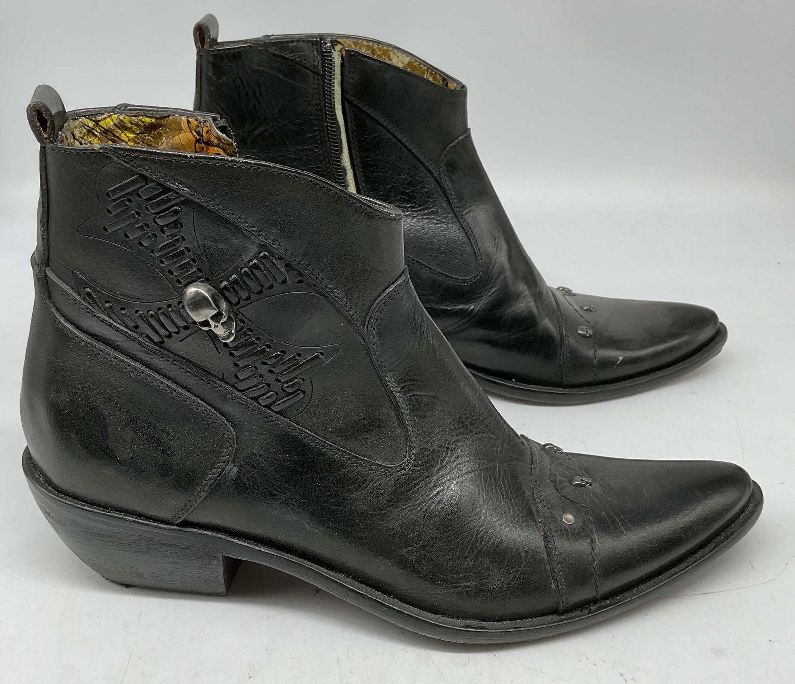 Mark Nason Black Leather Skull Boots, Italy: Siren by Mark Nason black leather angle books with woven leather cross and silver tone skull decoration. Size 7.5. Made in Italy. Some wear to soles and leather consistent with exposure. One skull nee