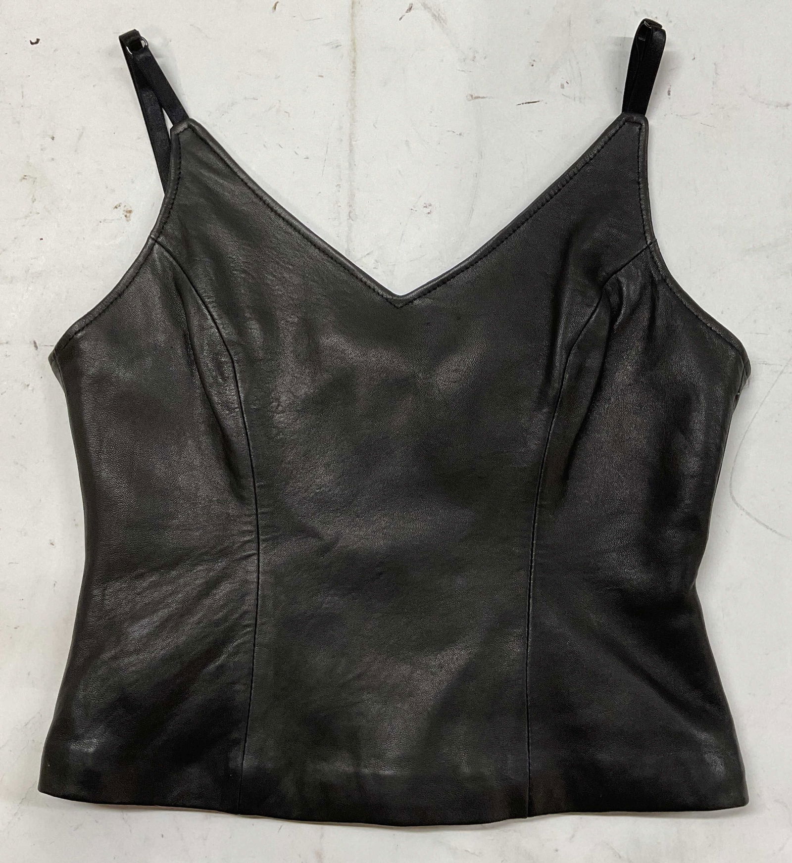 Lobi Black Leather Sleeveless Top: Lobi black leather sleeveless top. Size small. Outside contains leather material. Lining contains polyester material. Zipper on the back of garment. Some pulling on stitching. Inside printed with bran