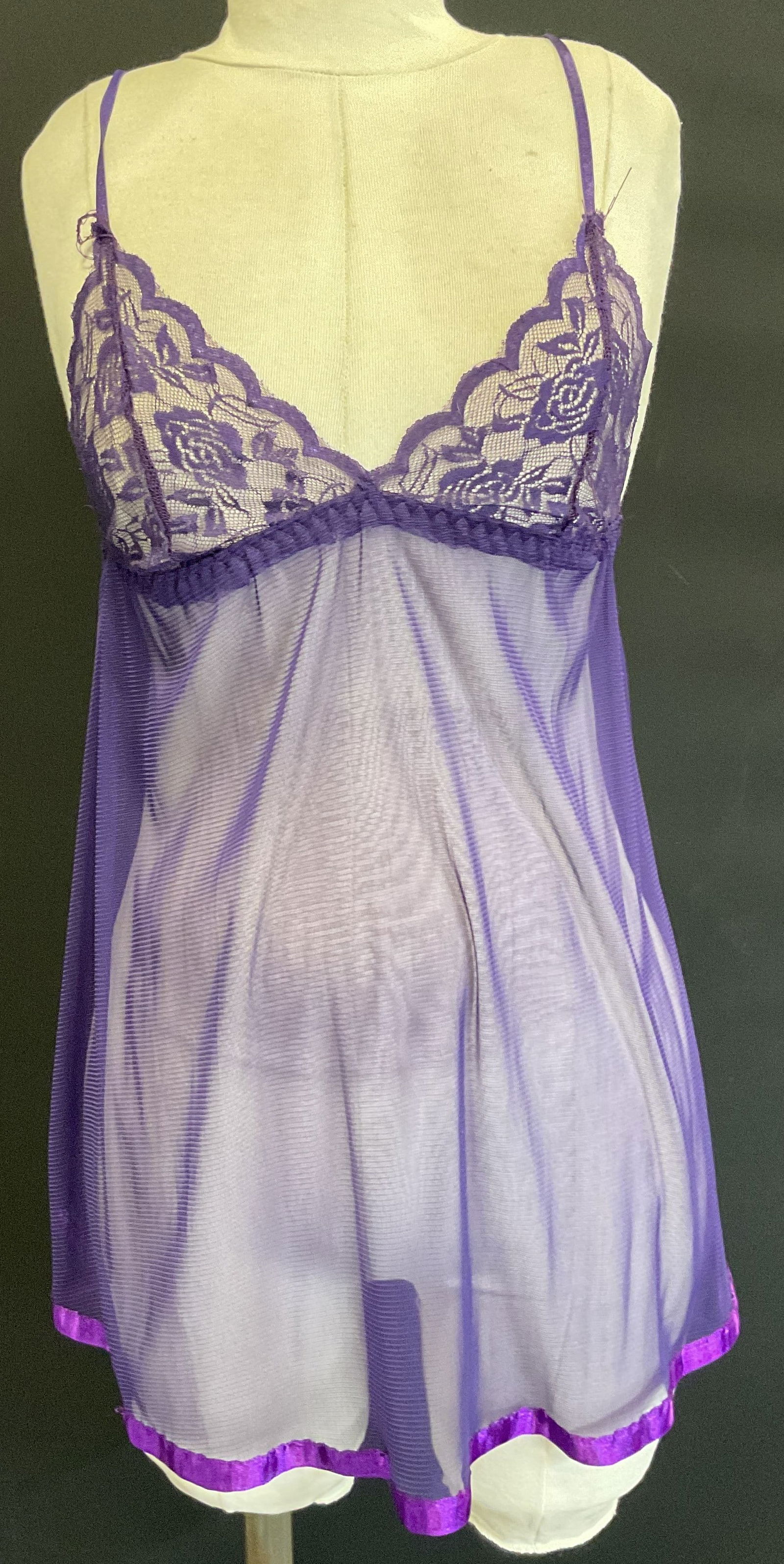 Sheer Purple Lace Sleeveless Top: Sheer purple lace sleeveless top. Measures approx 11 inches across chest. Feels like synthetic material. Some pulling on stitching across chest and trim. Property of 1980s known Rockers Manhattan esta