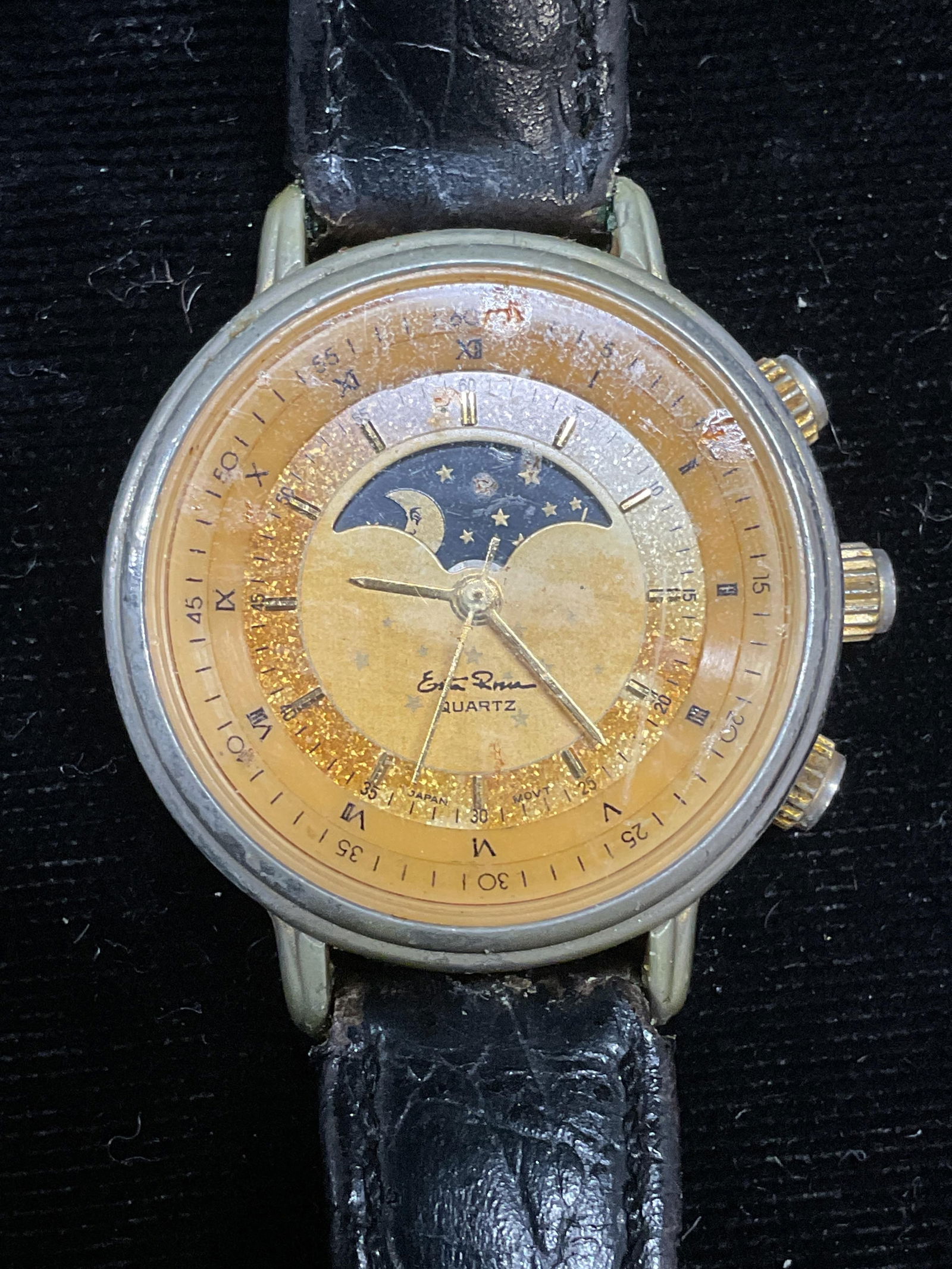 Esta Rossa Gold Tone Black Leather Watch: Esta Rossa gold tone watch with celestial motif dial. Black leather strap. Signed. Measures approx 7.75 inches long. Not tested. Some scratching. Jewelry, estate jewelry, costume jewelry, cocktail jew