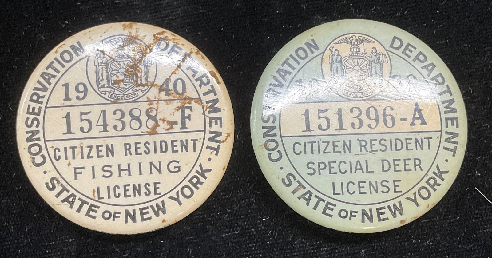 Lot 2 Vntg 1939/40 Hunting & Fishing License Pins: Lot of 2 New York State fishing and deer hunting license pins. Dated 1939 and 1940. Measure approx 1.75 inches wide. Some scratching and residue. Vintage hunting pin, vintage fishing pin, New York, co