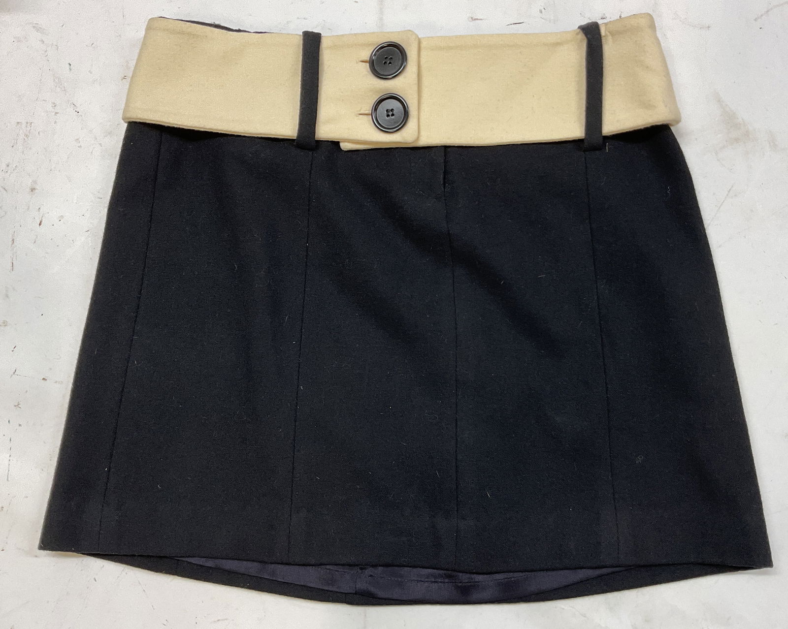 Launuky Black Wool Mini Skirt USA: Launuky black wool mini skirt. Cream wool belt with black buttons. Size 2. Made in USA. Wool and rayon blend. Fully lined. Property of 1980s known Rockers Manhattan estate. Mini skirt wool womens fash