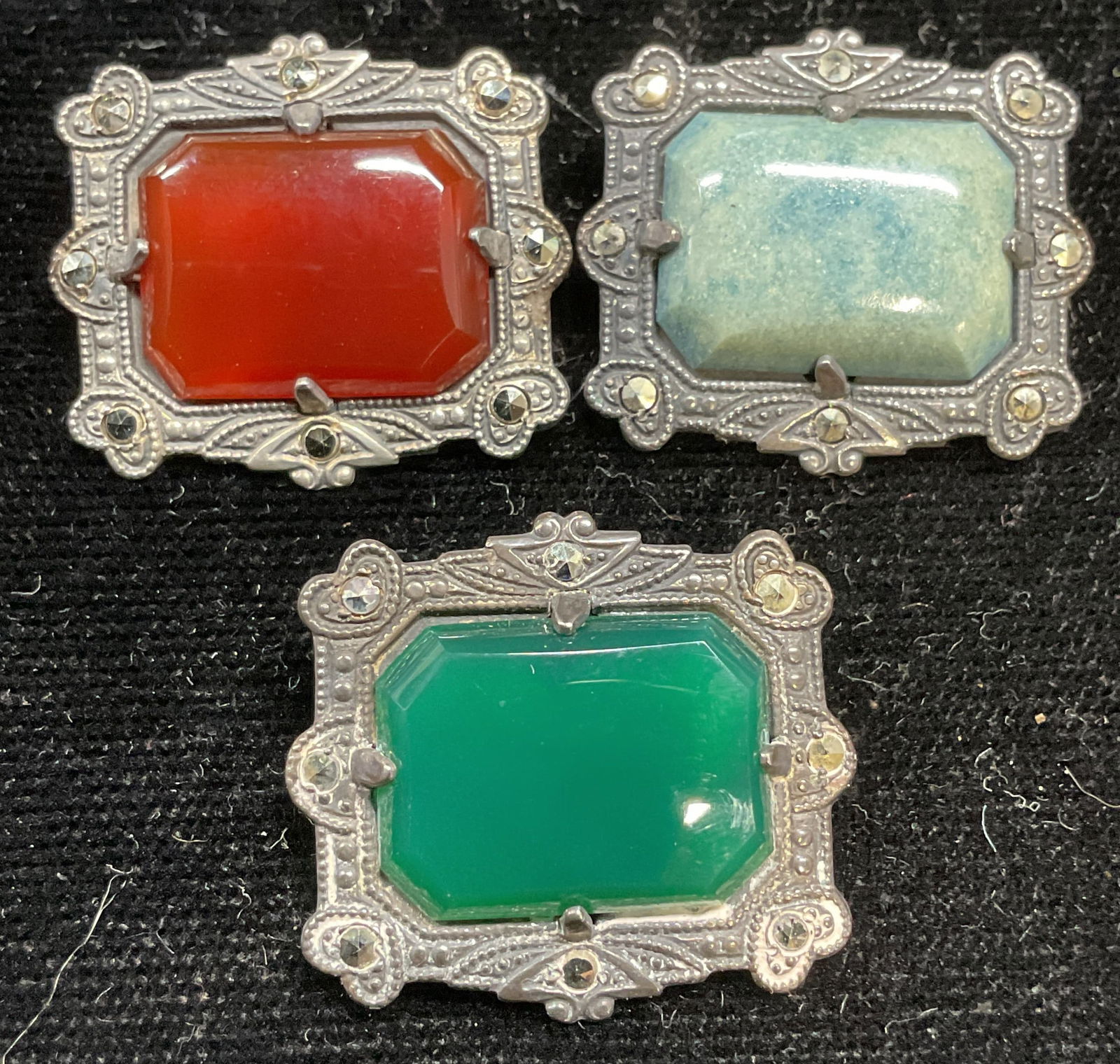 Lot 3 Signed Sterling Silver Semiprecious Brooches: Lot of 3 signed Sterling silver brooches with emerald, carnelian, blue agate, and marcasite. Marked sterling. Measure approx .75 x 7/8 inches. Total weight of all 10.5 grams. -10j