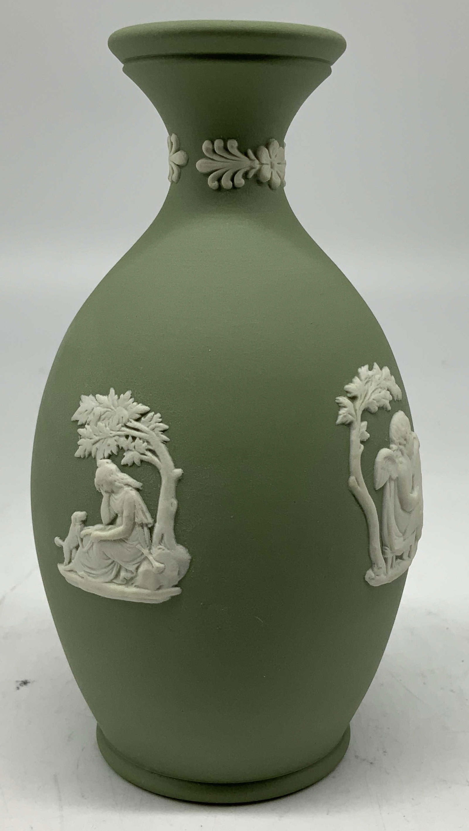 Wedgwood Green Jasperware Bud Vase ENGLAND: Bud vase features white relief Greek mythological & cupid figures. Green matte toned. Signed & marked. Reads, WEDGWOOD. MADE IN ENGLAND. Surface wear consistent to age, use & exposure. Measurements: l