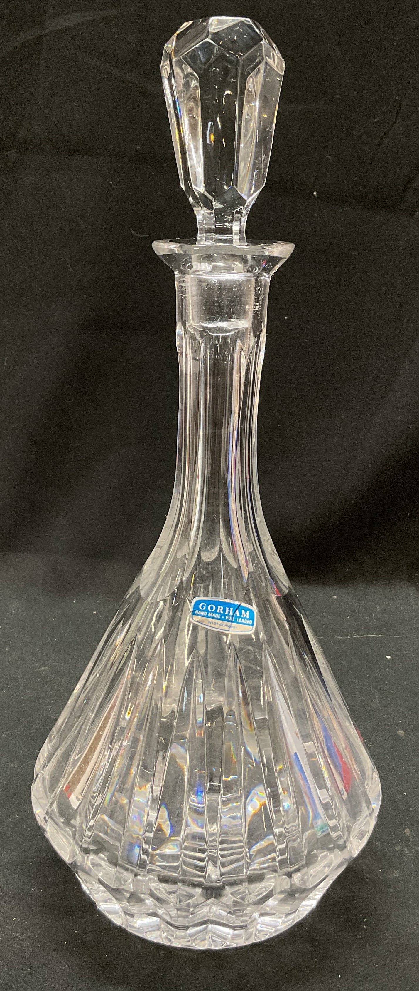 Gorham Hand Made Crystal Decanter W Stopper DE: Gorham hand made crystal glass decanter with stopper. Made in West Germany. Sticker is affixed to surface. Sticker reads as follows Gorham Hand Made Full Leaded West Germany. Features a wide base and