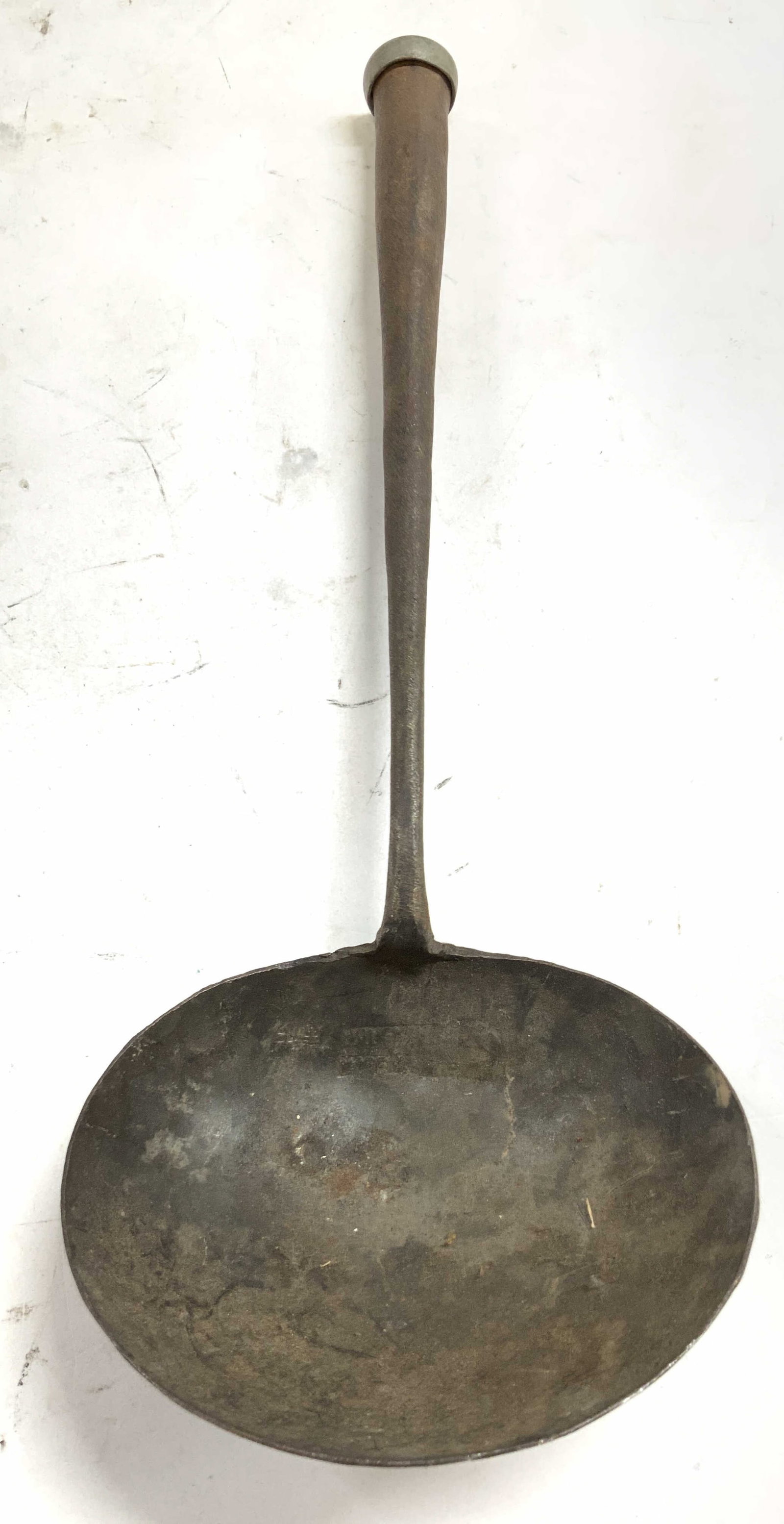 Antique Trademarked Iron Rustic Soup Ladle 12.5in: Basin is trademarked illegibly. Soup ladle is Antique. Ladle has metal cap at end of handle. Appears to possibly be hand crafted. Rustic Iron Soup ladle. Piece measures approximately 12.5 inches long 