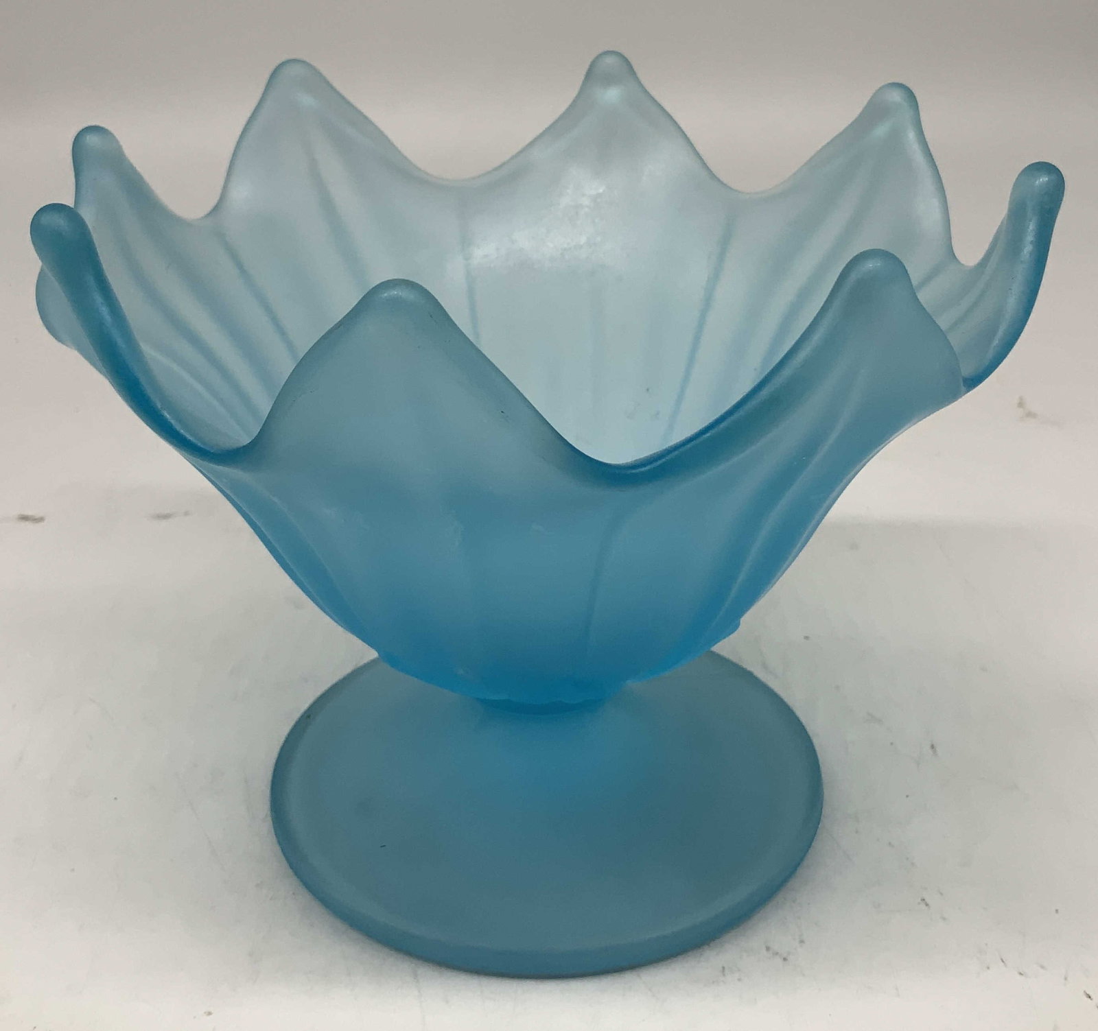 Vtg Blue Satin Glass Lotus Pedestal Candy Dish: Candy dish is vintage & features a blue satin finish. Pedestal base, ruffled rim that resembles petals. Piece appears to be possible Westmoreland. No visible signature or markings. Surface wear consis