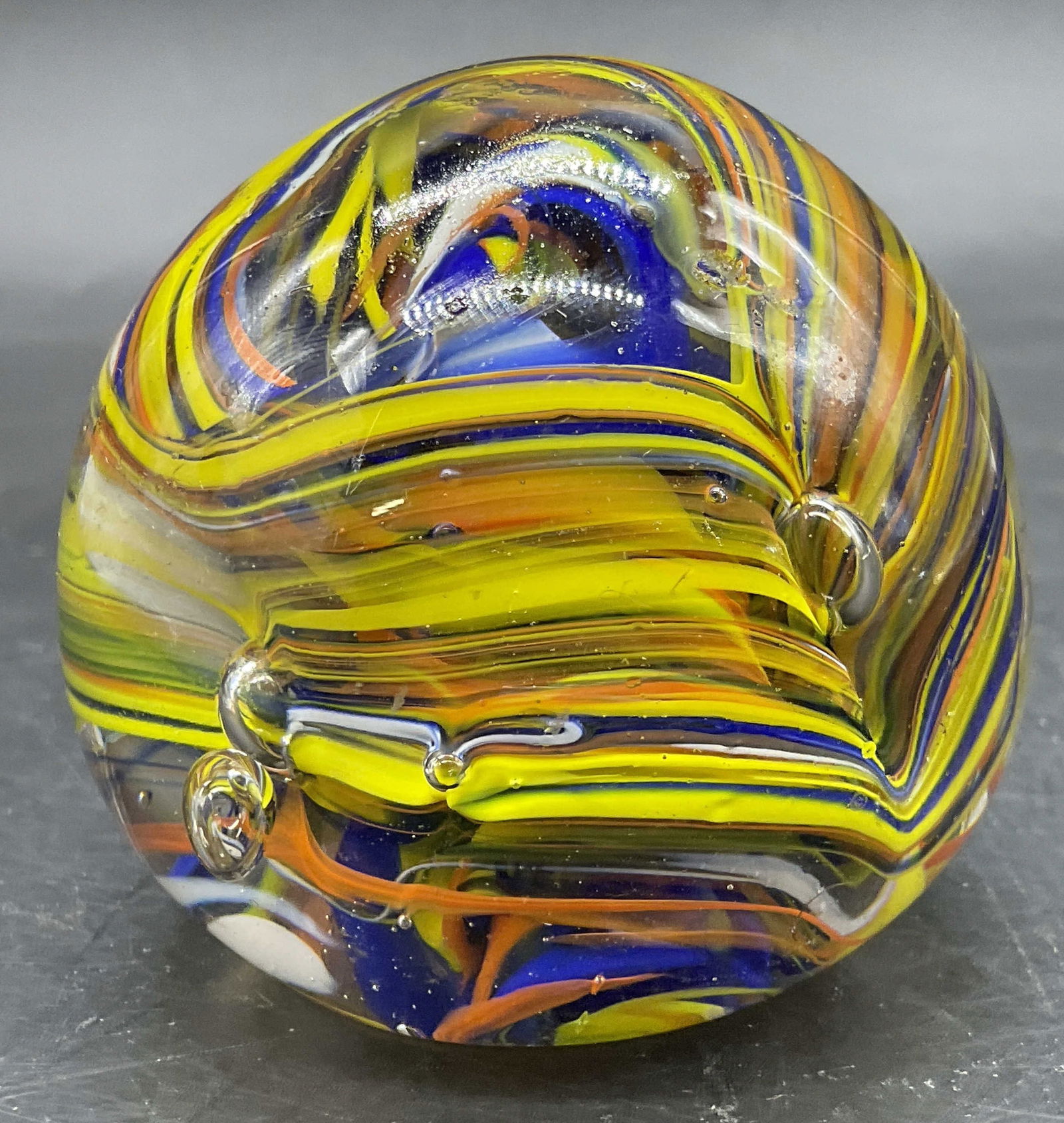 Vintage Art Glass Multicolored Paperweight: Vintage Art Glass Multicolored Paperweight. Bubbles to the interior surrounded by swirls of color. Measures approx. 2.5H x 2.25W in. Pitting and surface wear present. home decor, home accents, homewar