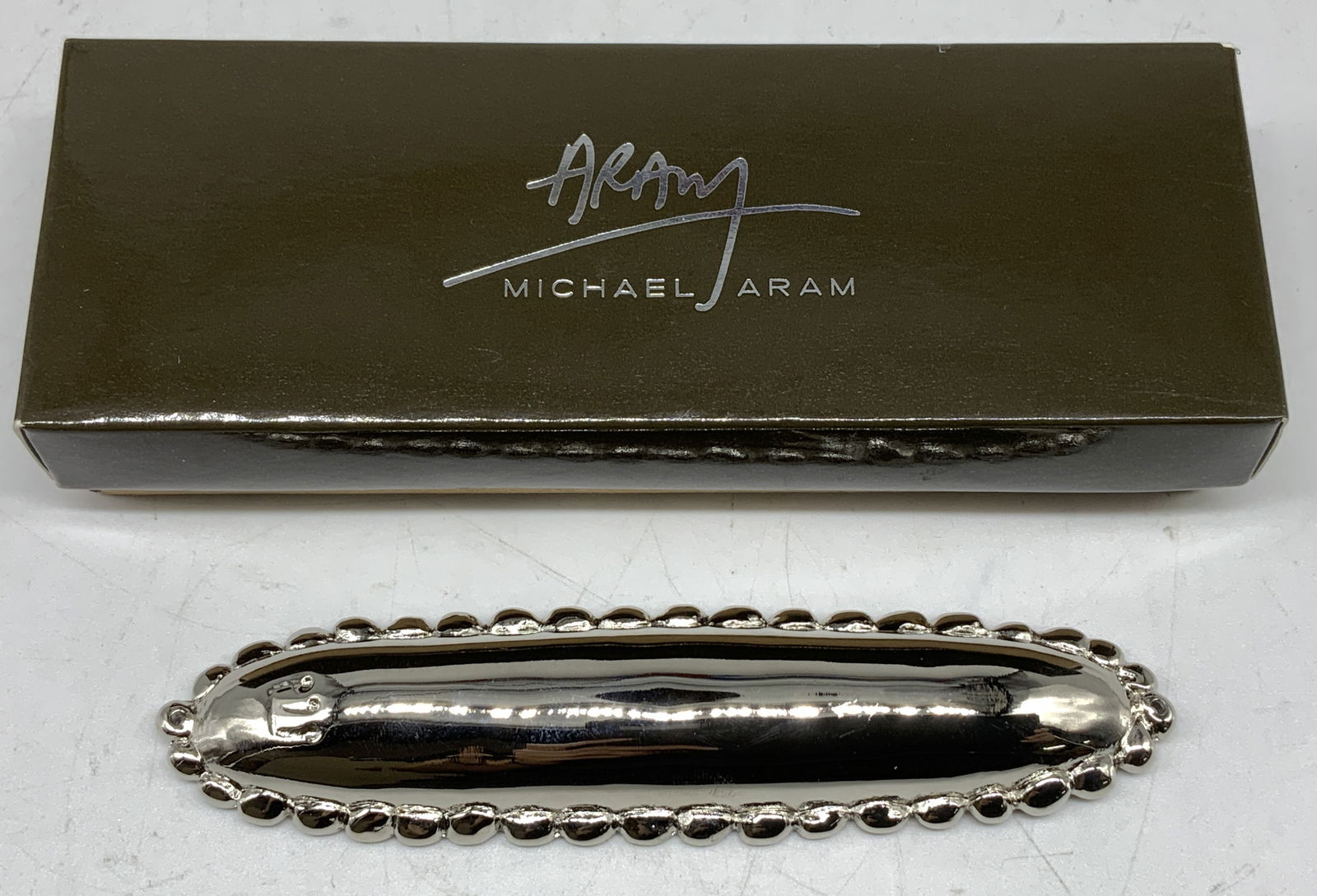 Michael Aram Molten Mezuzah W Org Box: Mezuzah is made of nickel plate & features intricate, hand-welded edges. Pieces come with original Michael Aram box. Surface wear consistent to age, use & exposure. Measurements: length 5in x width 1.