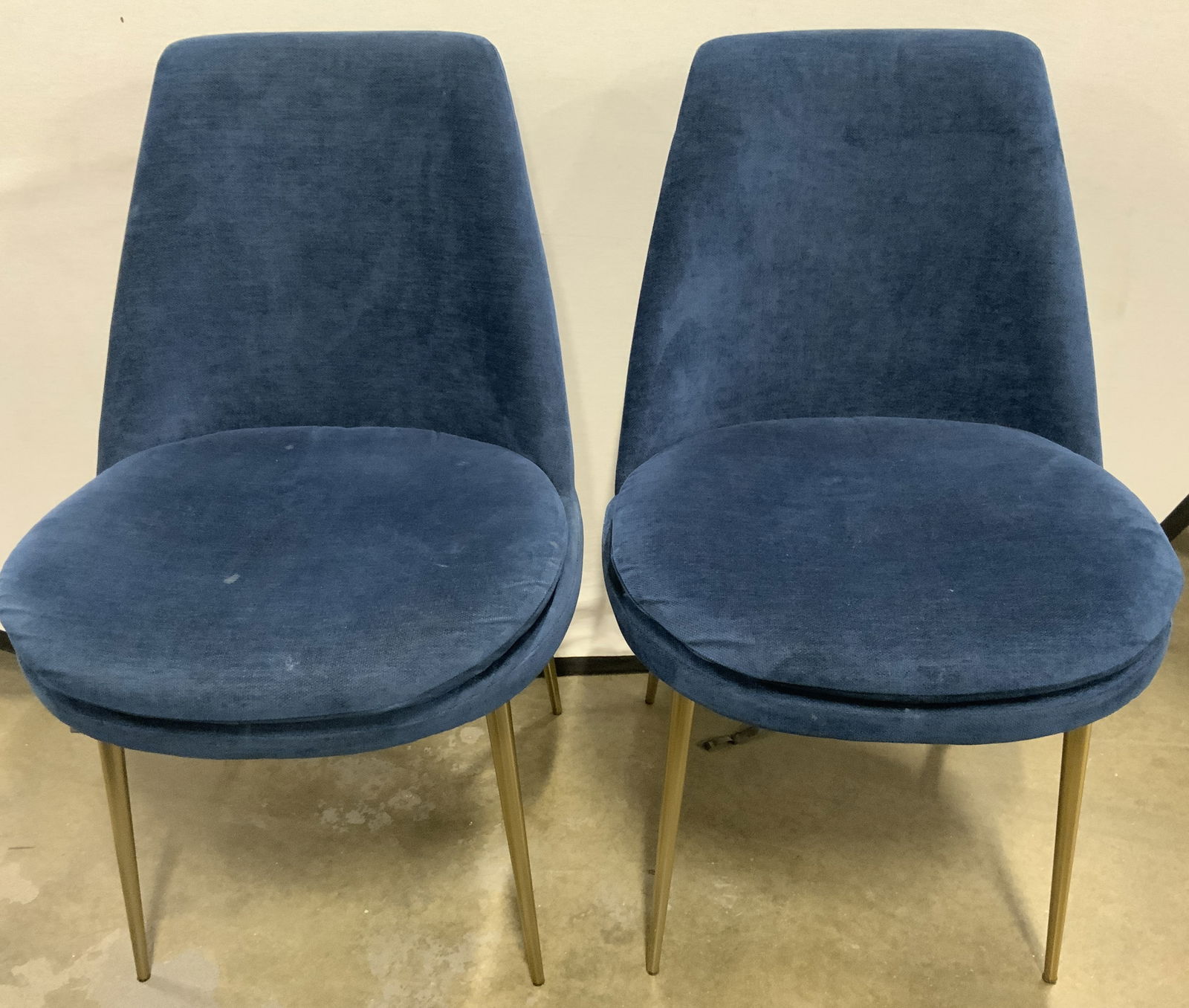 Pr MCM West Elm Finley Low-Back Velvet Dining Chrs: Undersides of each chair have tags which read WEST ELM. Low back FINLEY chairs with splayed gilt metal legs. Lot includes 2 chairs. Each have ink blue toned velvet upholstery. Each measures approximat